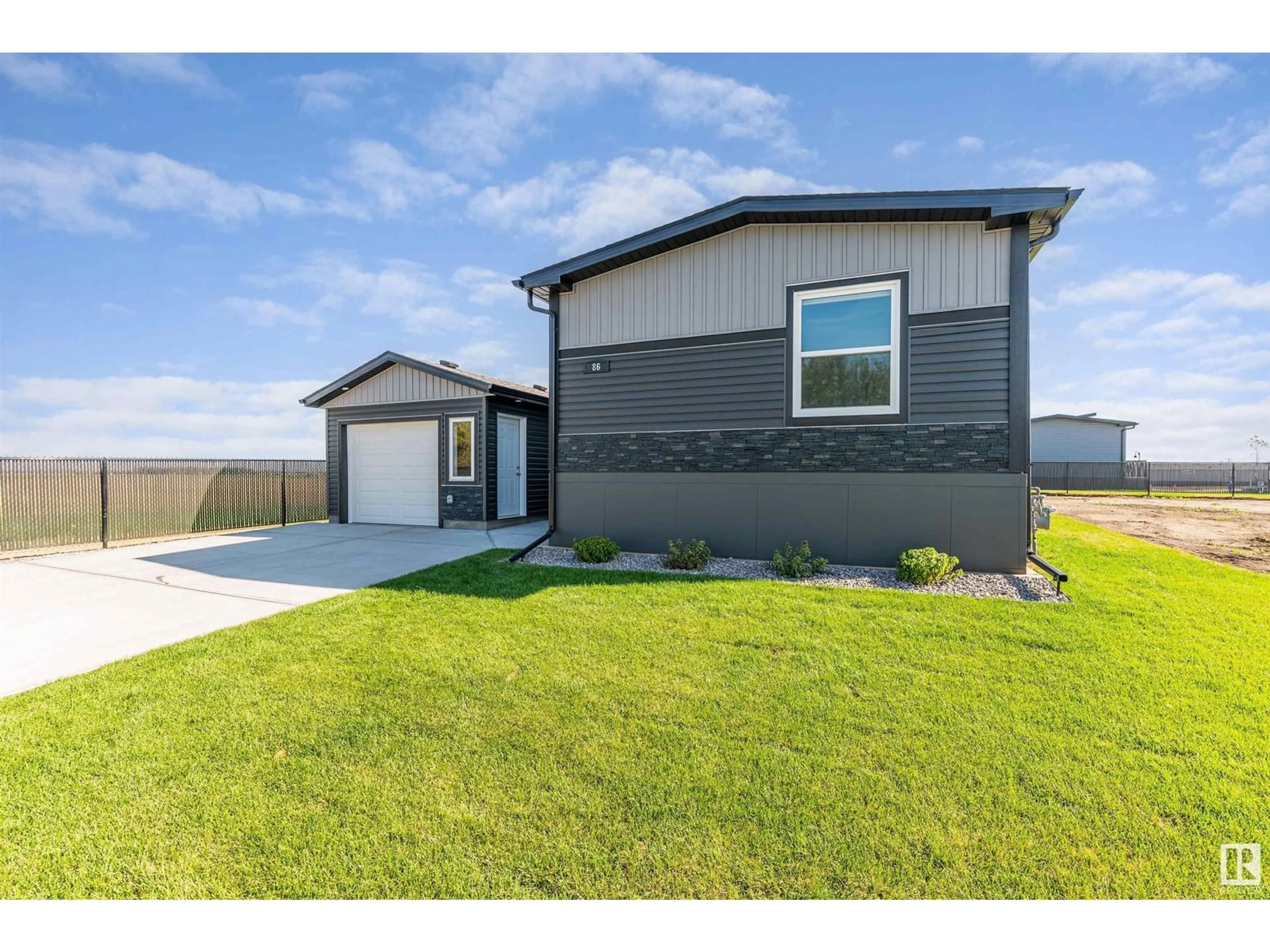 Frontside or backside of a home, the fenced backyard for 86 Meadowview RD, Morinville Alberta T8R2P7