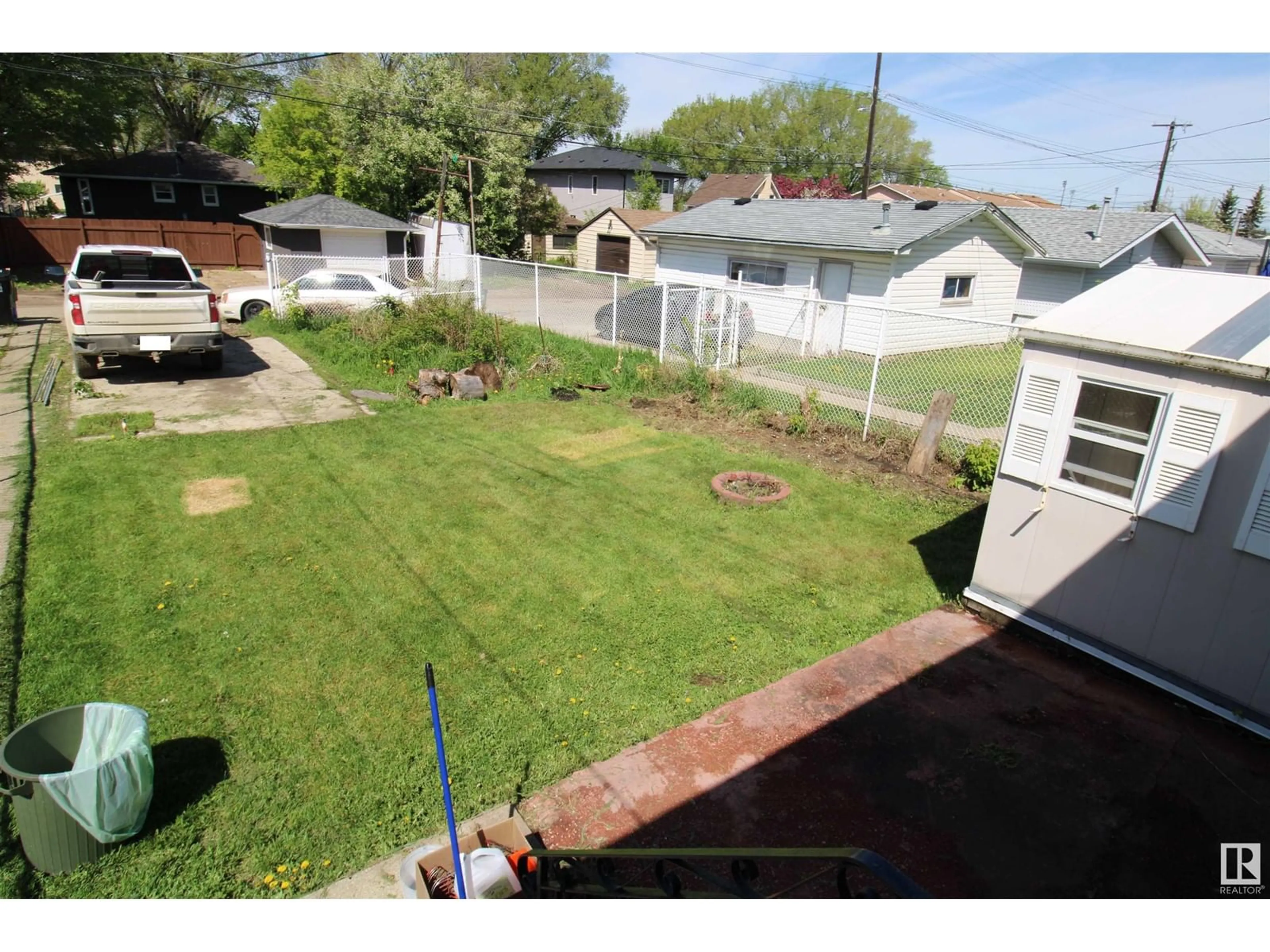 Frontside or backside of a home, the fenced backyard for 11920 69 ST NW, Edmonton Alberta T5B1S5