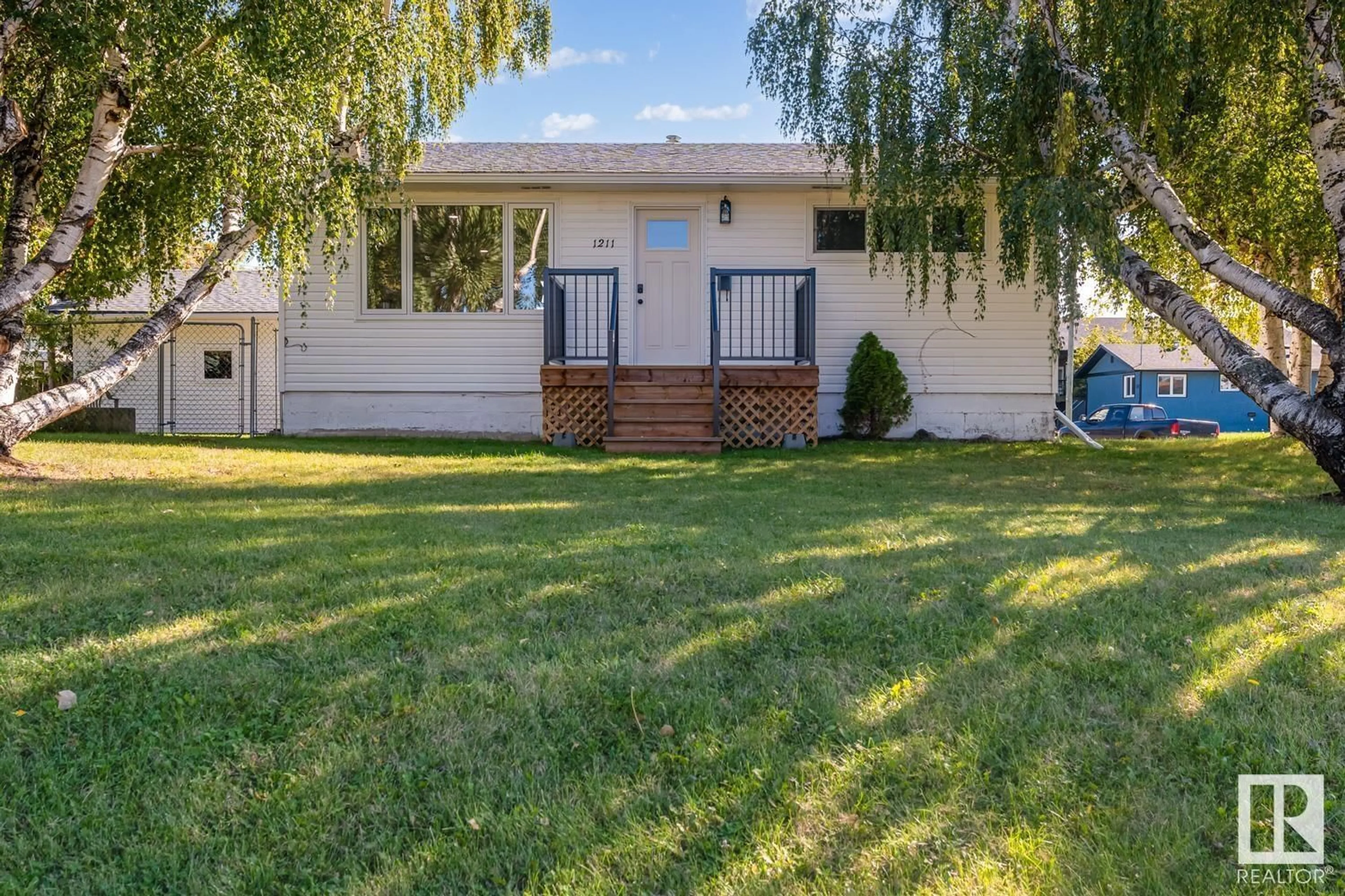 Frontside or backside of a home, the fenced backyard for 1211 5 AV, Cold Lake Alberta T9M1A8