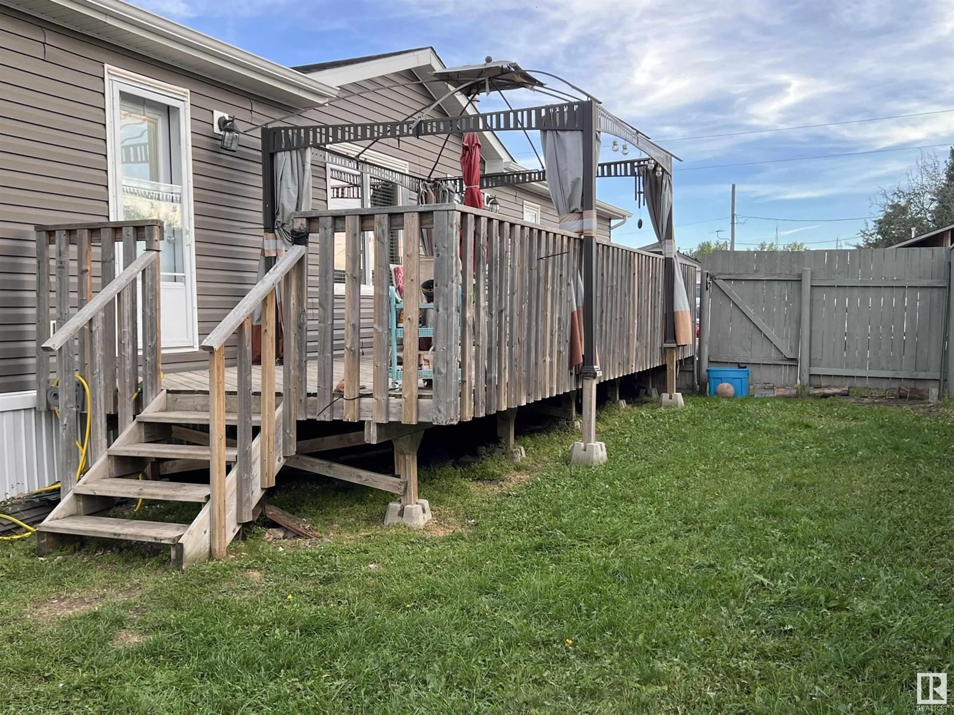 Frontside or backside of a home, the fenced backyard for C 30 6402 52 Av (Poplar Ridge MHP), Drayton Valley Alberta T7A1N4