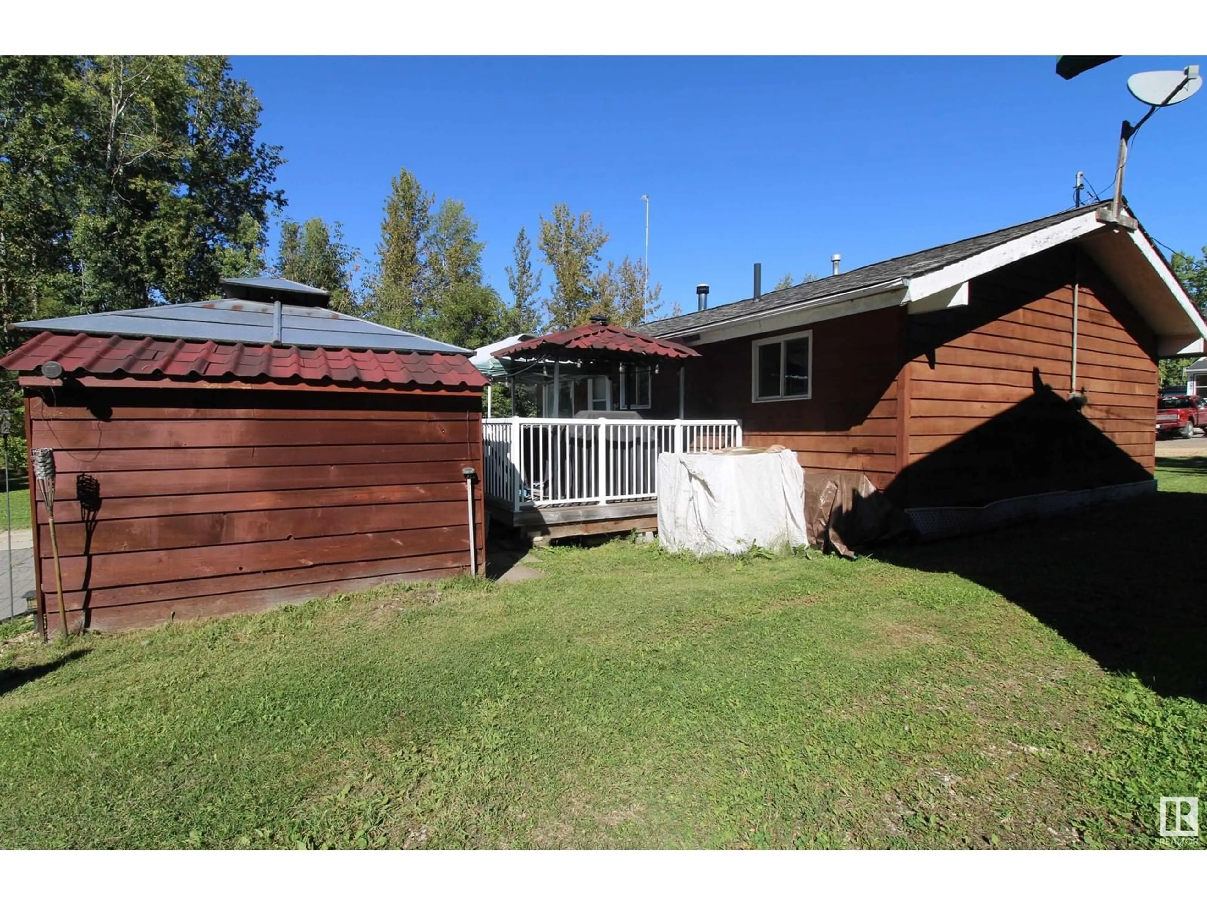 Frontside or backside of a home, the fenced backyard for 4 Aspen AV, Rural Lac Ste. Anne County Alberta T0E0L0