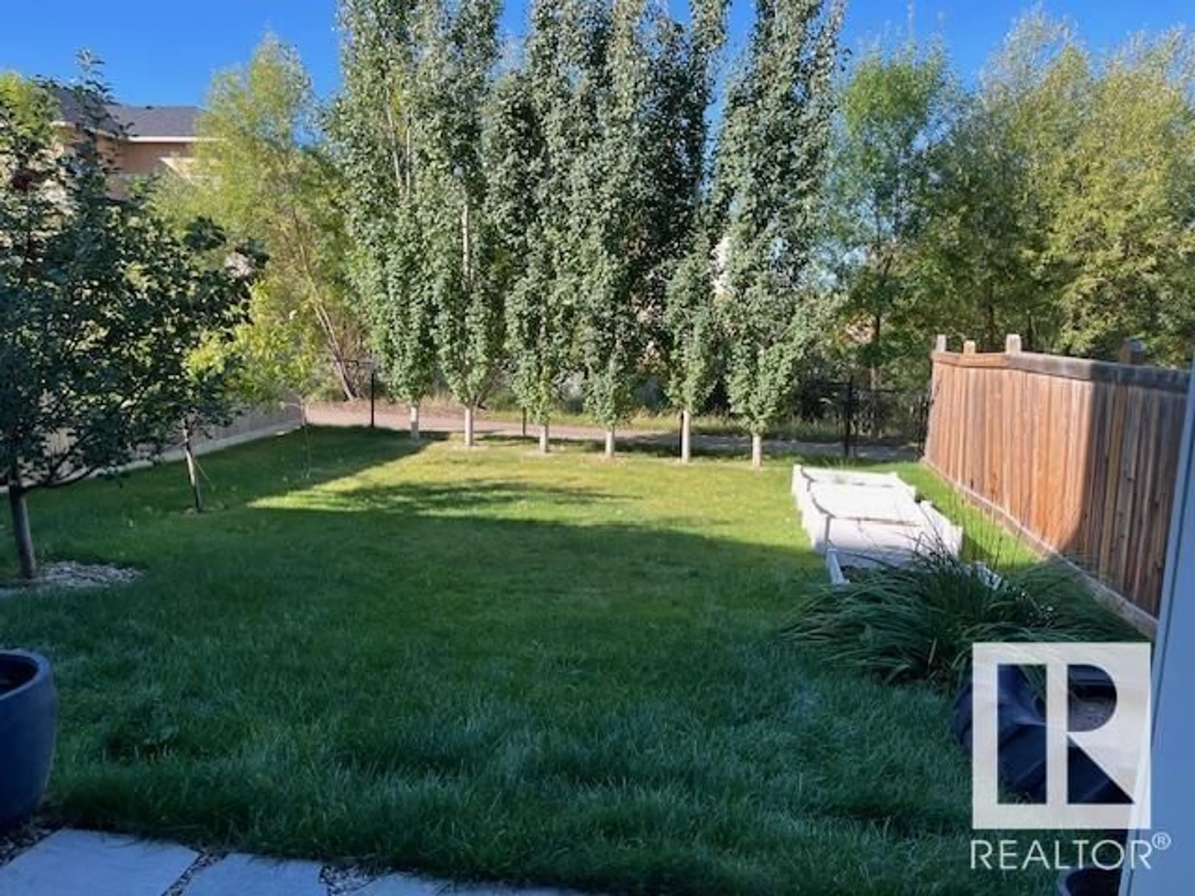 Frontside or backside of a home, the fenced backyard for 2022 REDTAIL CM NW, Edmonton Alberta T5S0H2