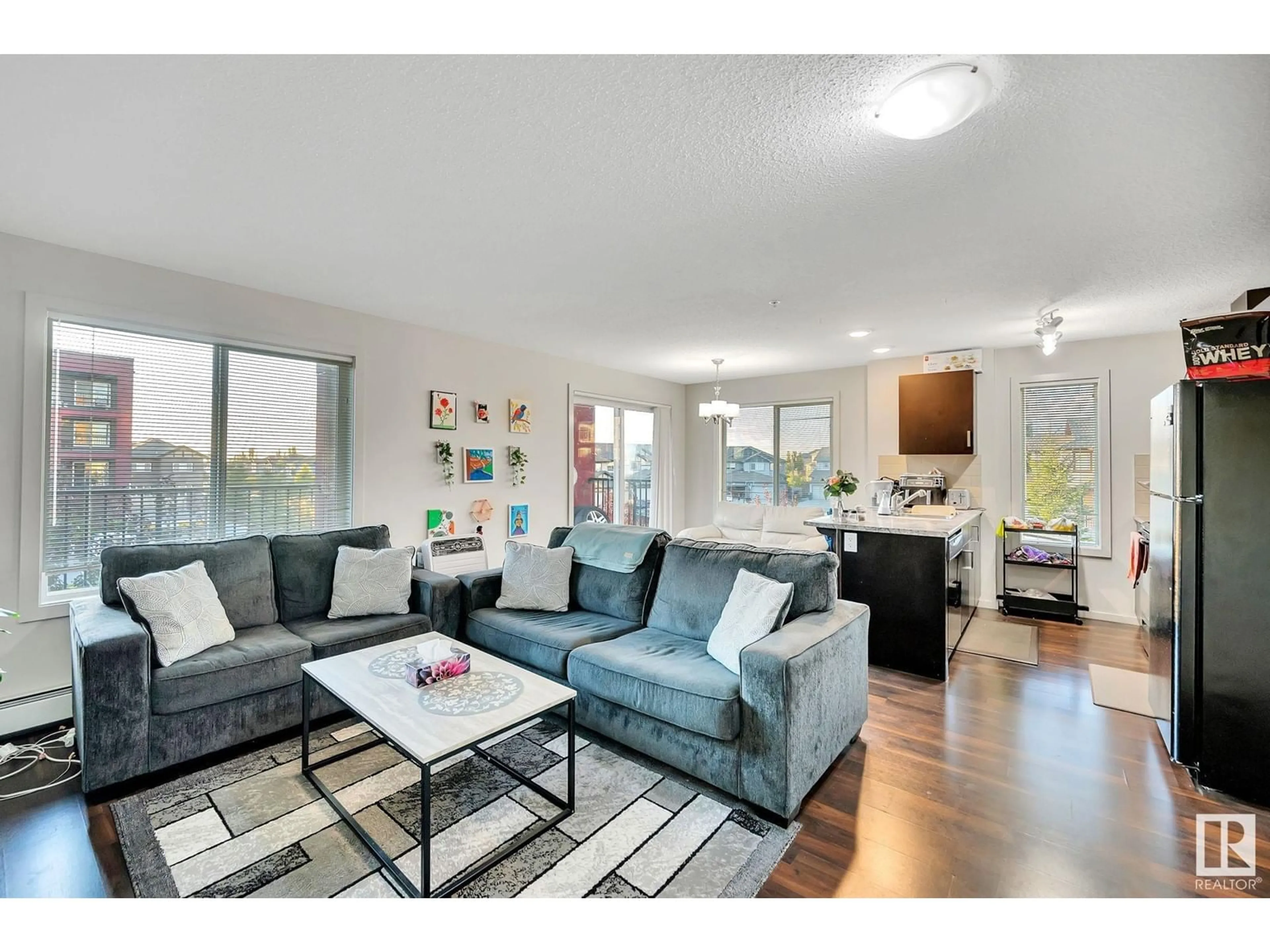 Living room, wood floors for #219 5515 7 AV SW, Edmonton Alberta T6X2A8