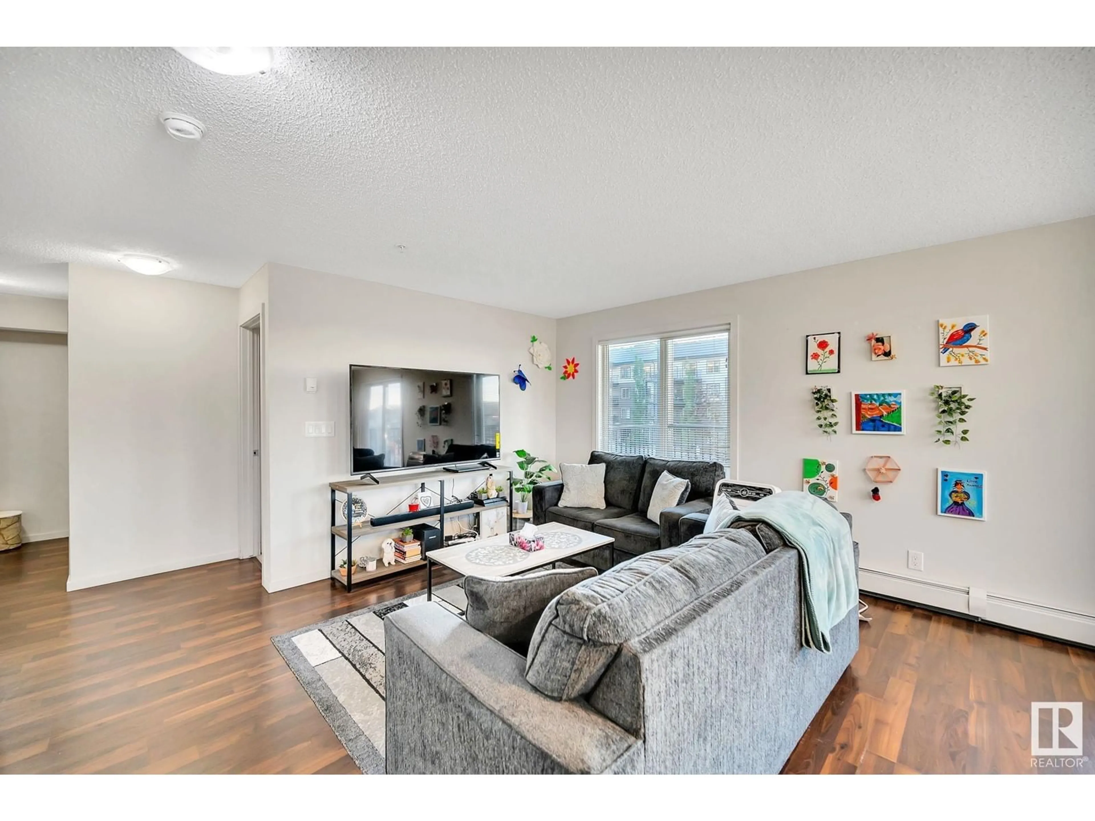 Living room, wood floors for #219 5515 7 AV SW, Edmonton Alberta T6X2A8