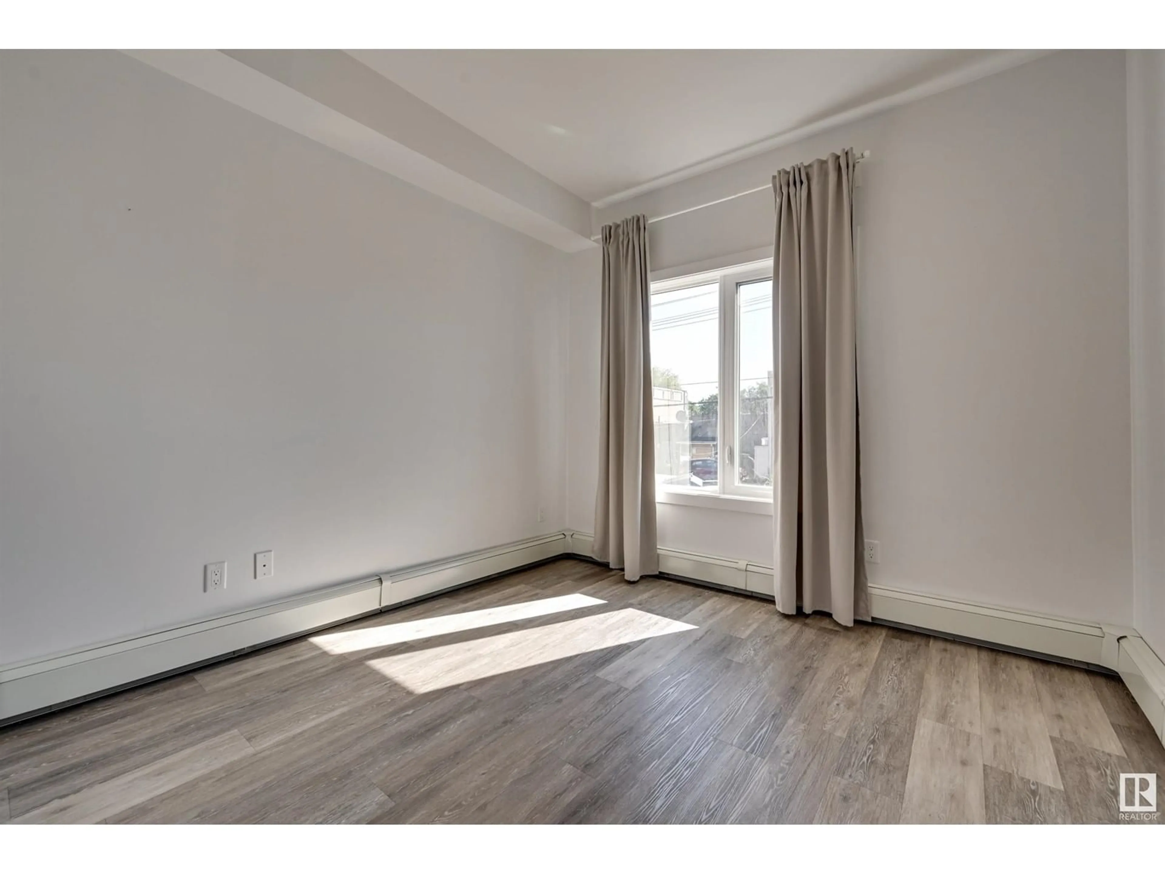 A pic of a room, wood floors for #206 10837 83 AV NW, Edmonton Alberta T6E2E6