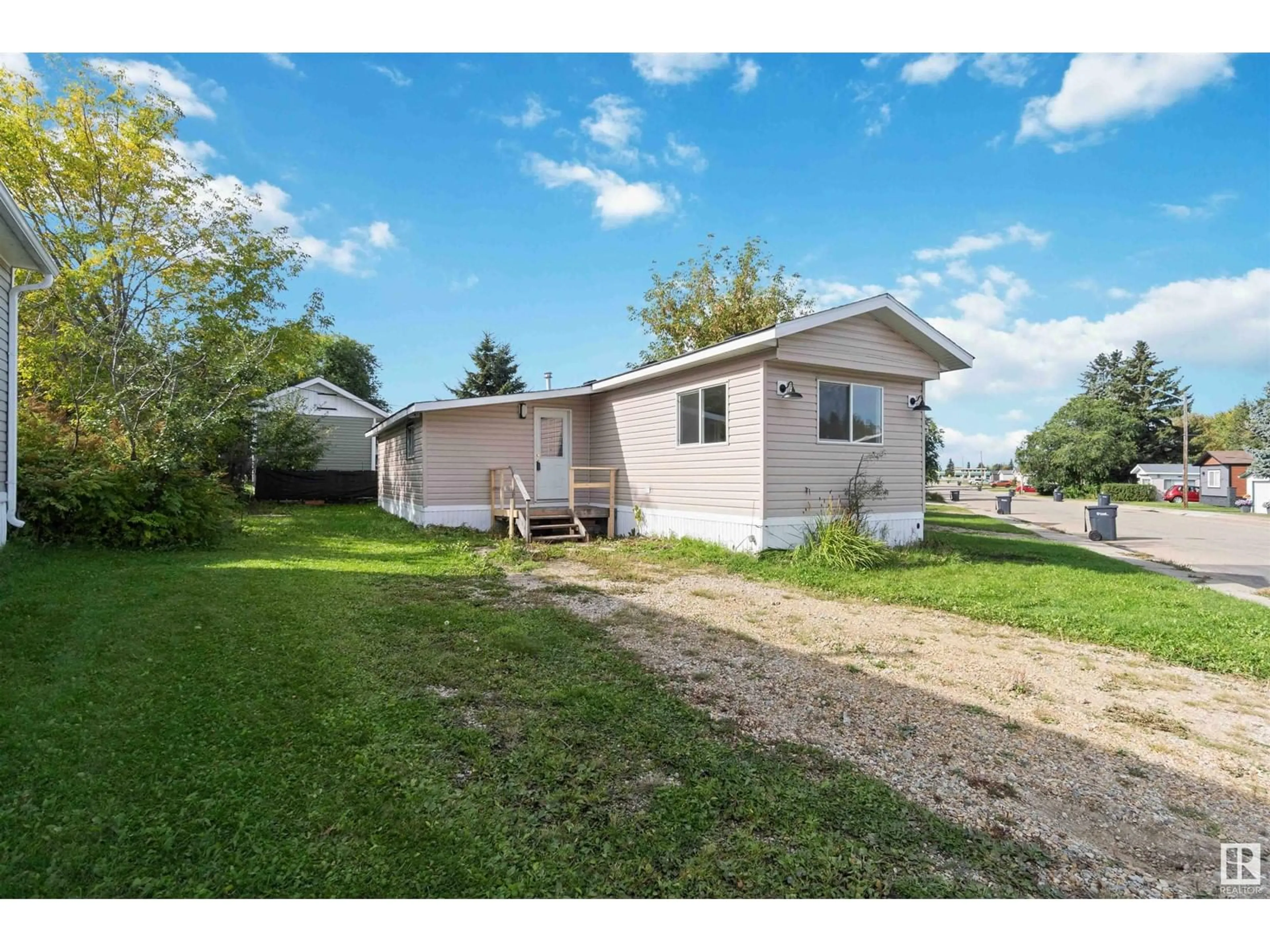 Frontside or backside of a home, the fenced backyard for #186 305 Calahoo RD, Spruce Grove Alberta T7X3K9