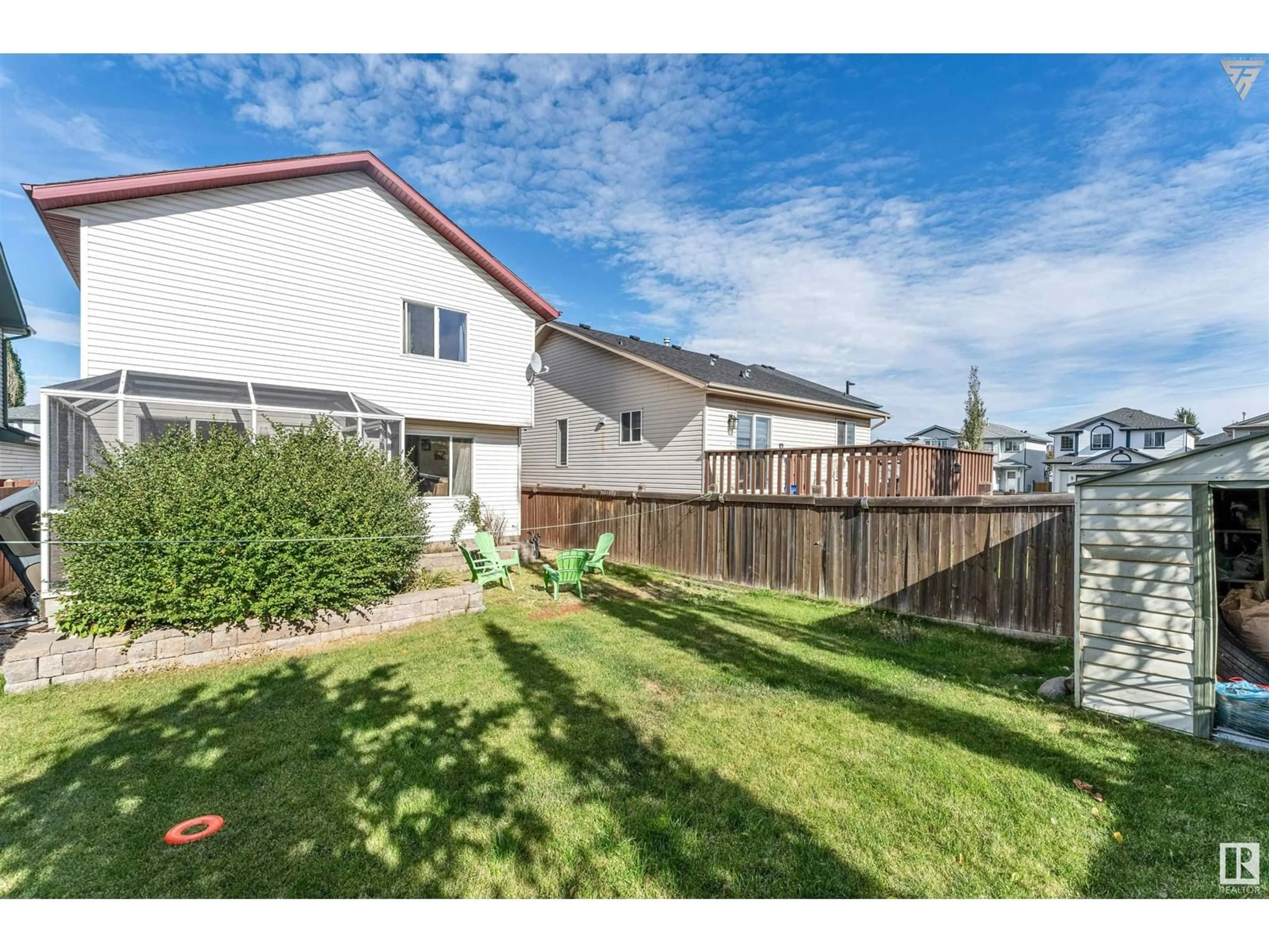 A pic from exterior of the house or condo, the fenced backyard for 3311 27 AV NW, Edmonton Alberta T6T1P7