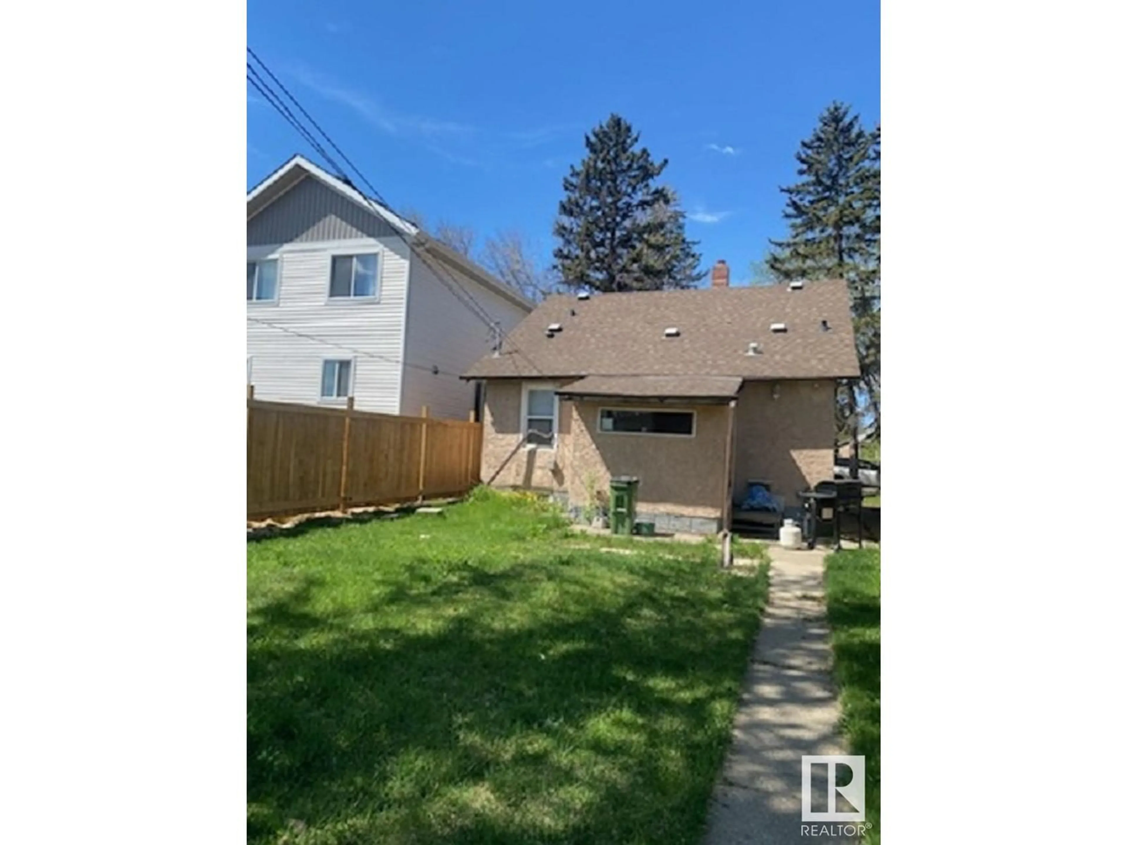 Frontside or backside of a home, the fenced backyard for 12723 116 ST NW, Edmonton Alberta T5E5H1