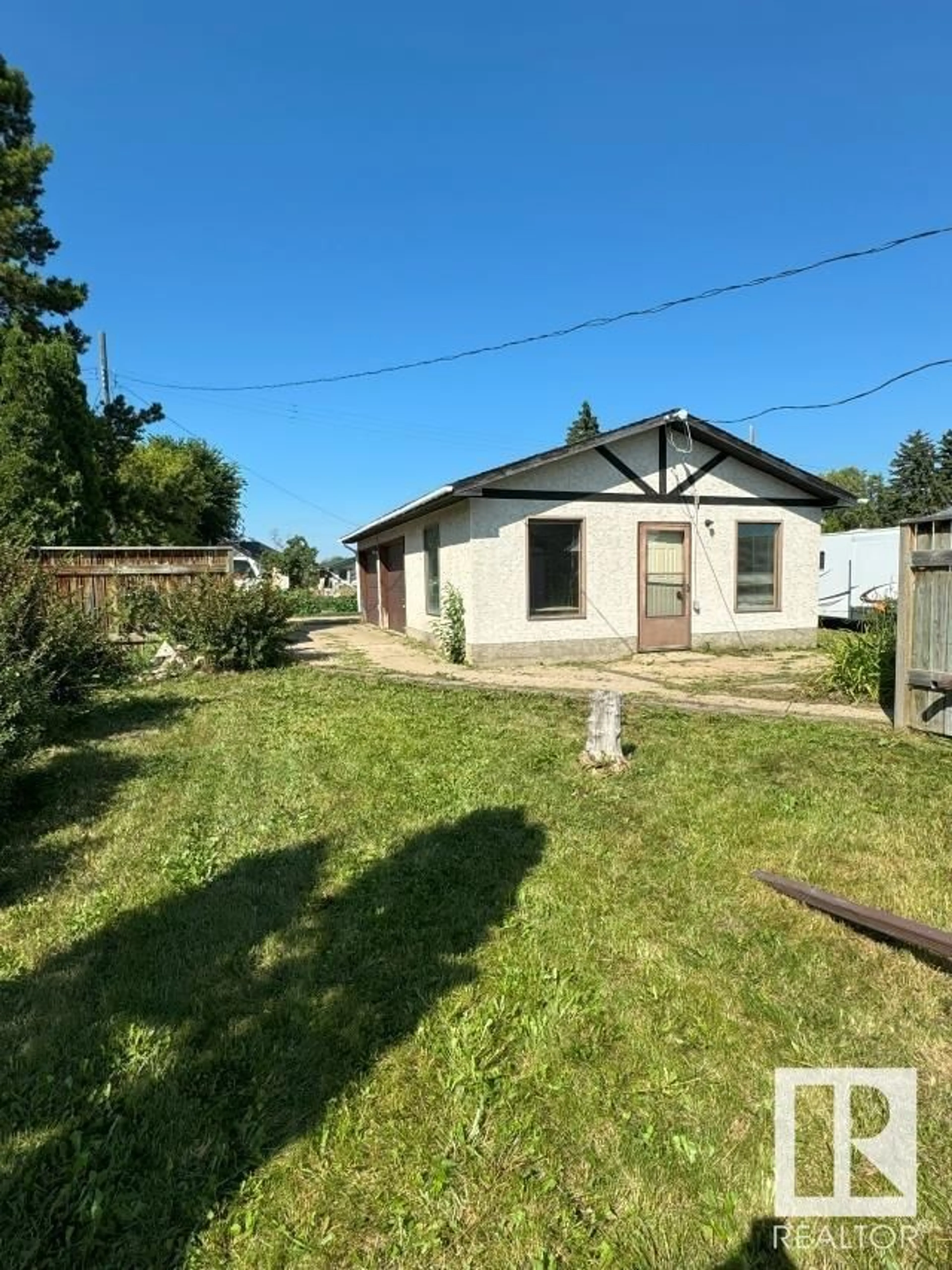 Frontside or backside of a home, the fenced backyard for 5022 50 AV, Warspite Alberta T0A0J0