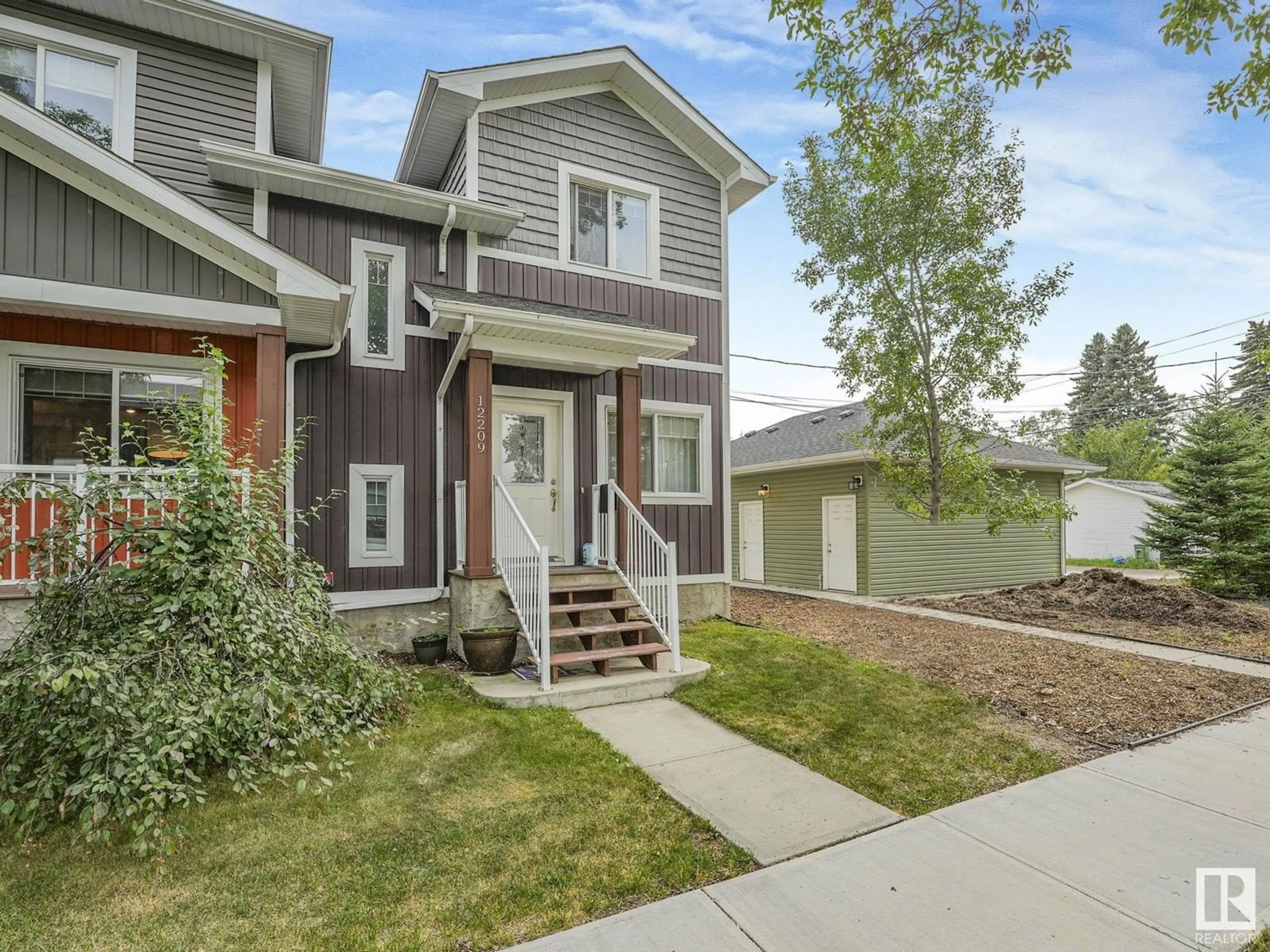 A pic from exterior of the house or condo, the fenced backyard for 12205/07/09 121 AV NW NW, Edmonton Alberta T5M2A3