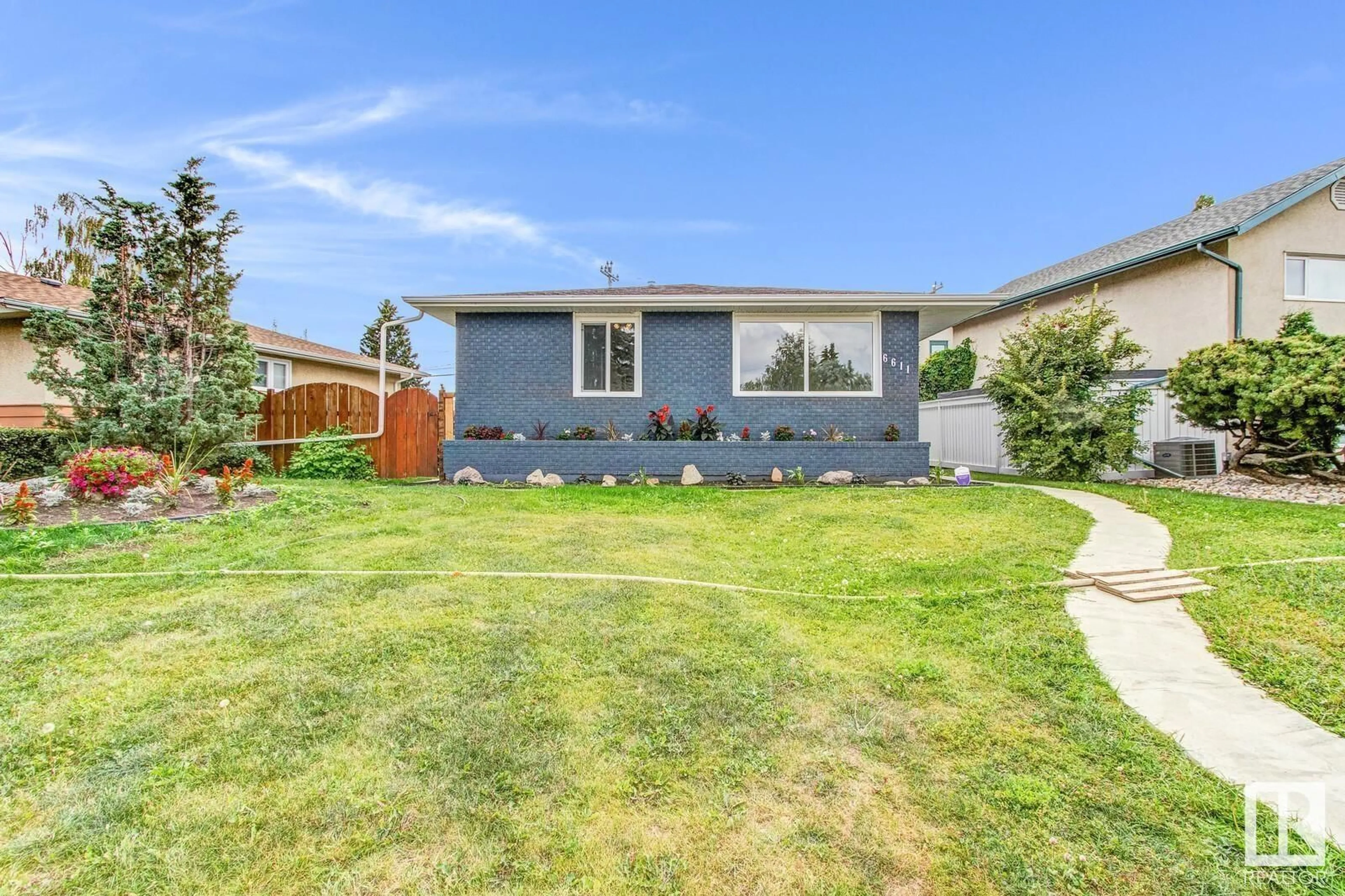 Frontside or backside of a home, the fenced backyard for 6611 89 AV NW, Edmonton Alberta T6B0N1