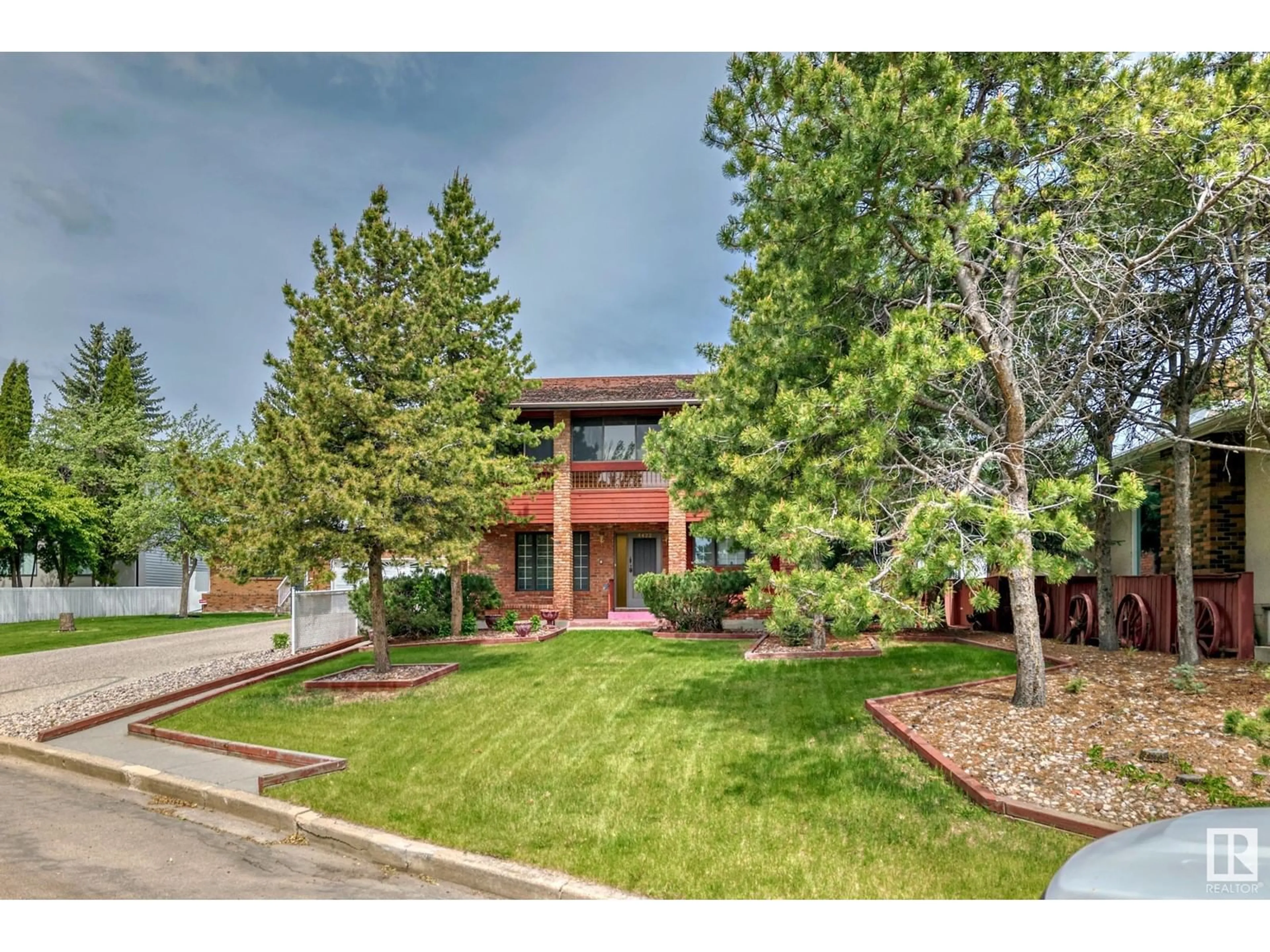 A pic from exterior of the house or condo, the fenced backyard for 4422 ADA BV NW, Edmonton Alberta T5W4M8