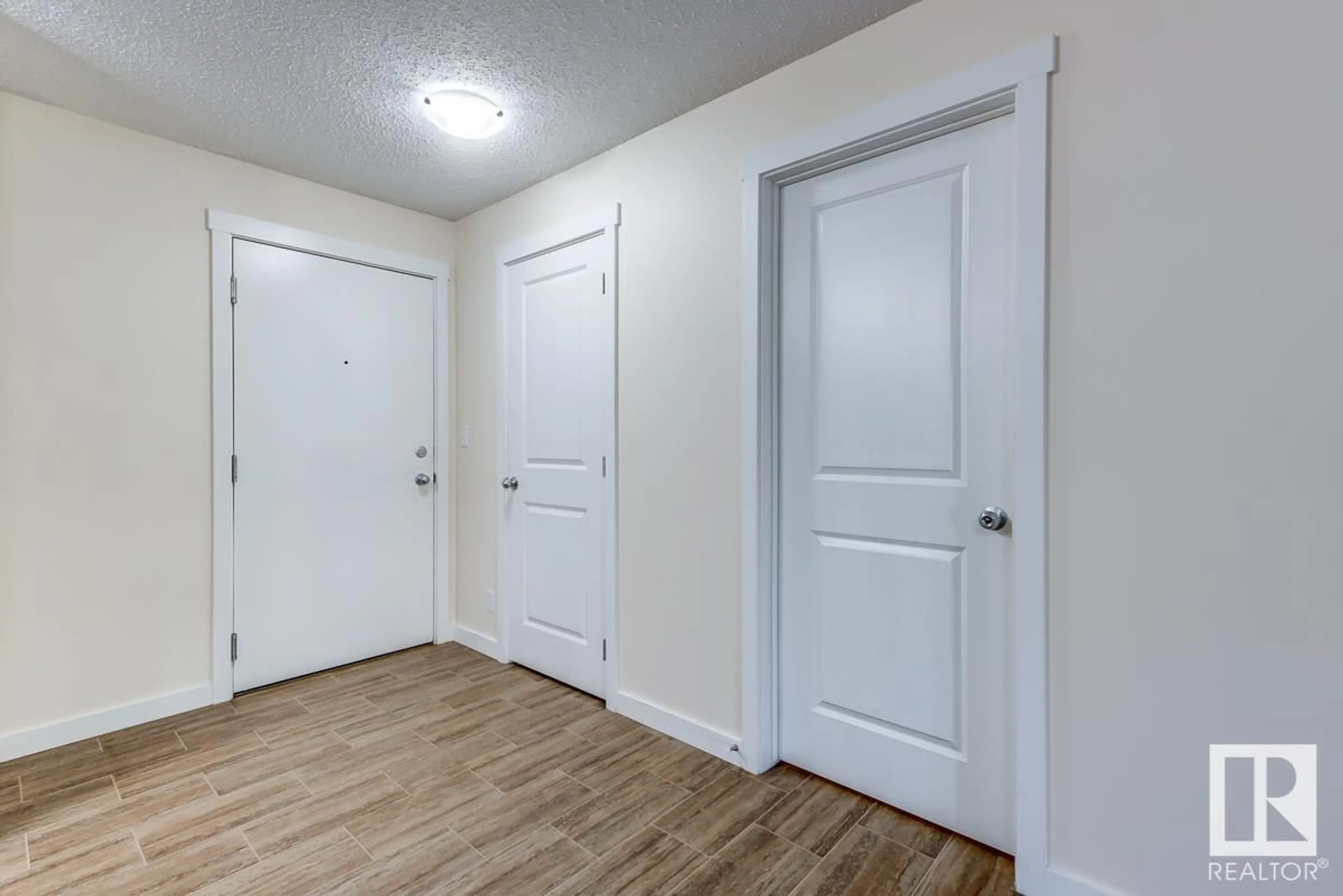 Indoor entryway, wood floors for #204 5816 MULLEN PL NW, Edmonton Alberta T6R0W3