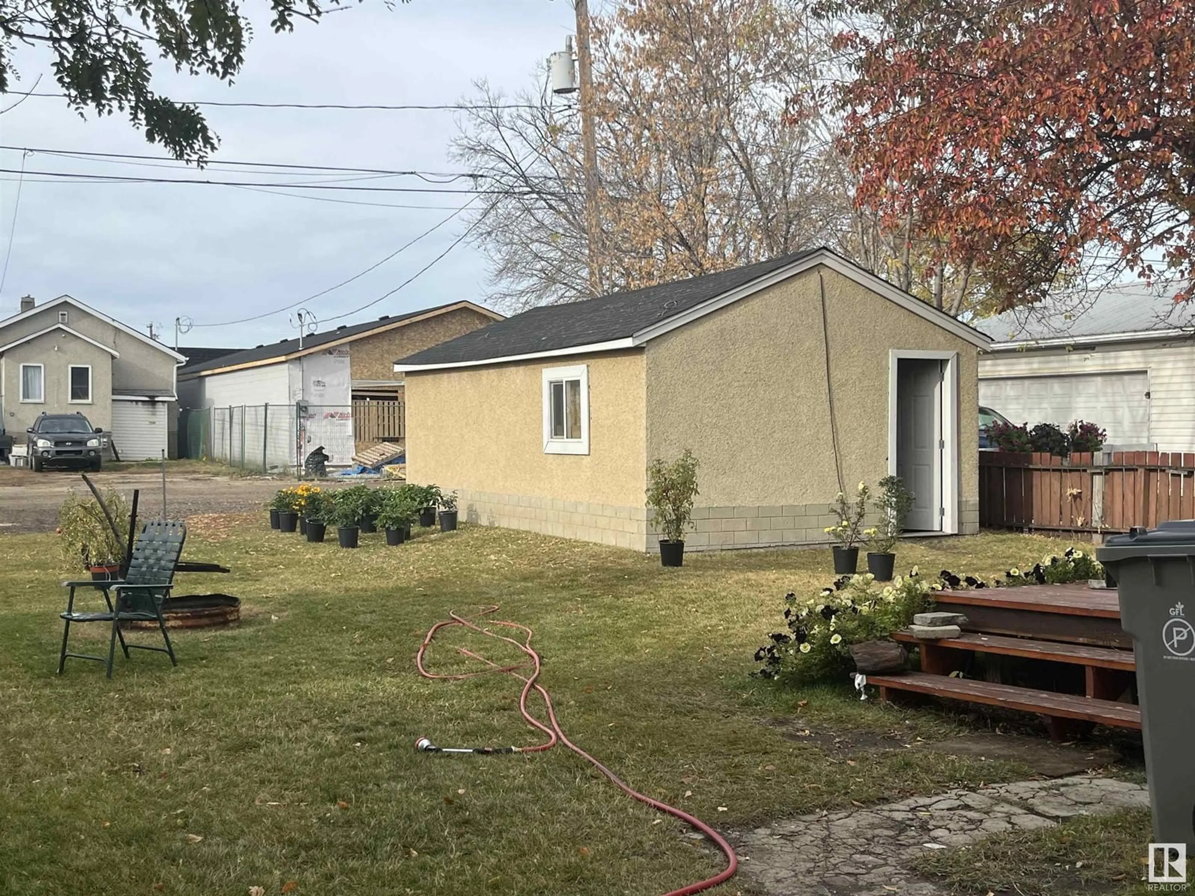 Frontside or backside of a home, the fenced backyard for 4924 48 Street, Redwater Alberta T0A2W0