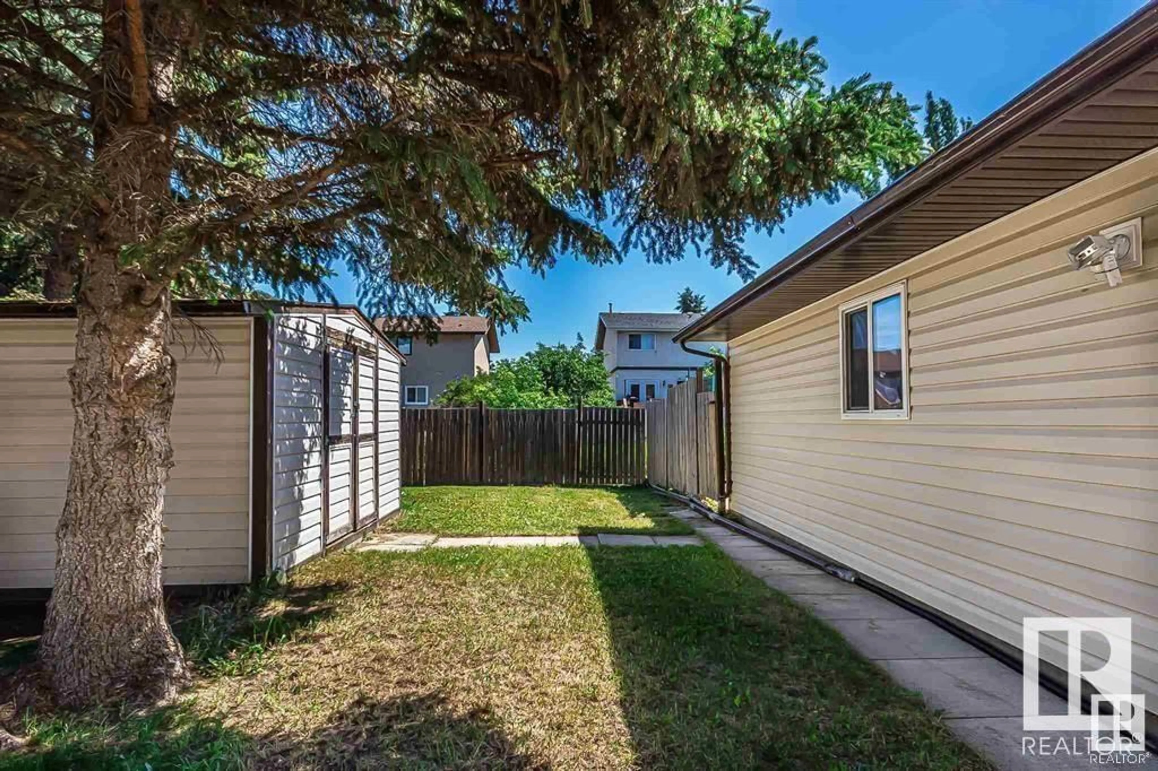 A pic from exterior of the house or condo, the fenced backyard for 218 20 ST, Cold Lake Alberta T9M1E2