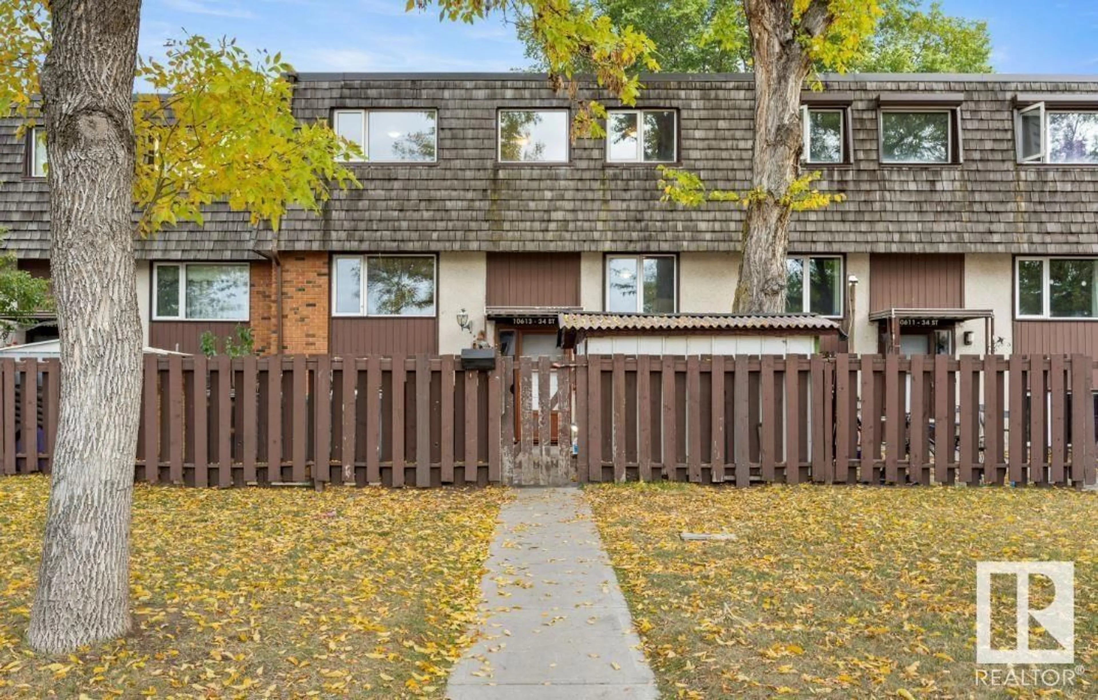 A pic from exterior of the house or condo, the fenced backyard for 10613 34 ST NW, Edmonton Alberta T5W1Y1