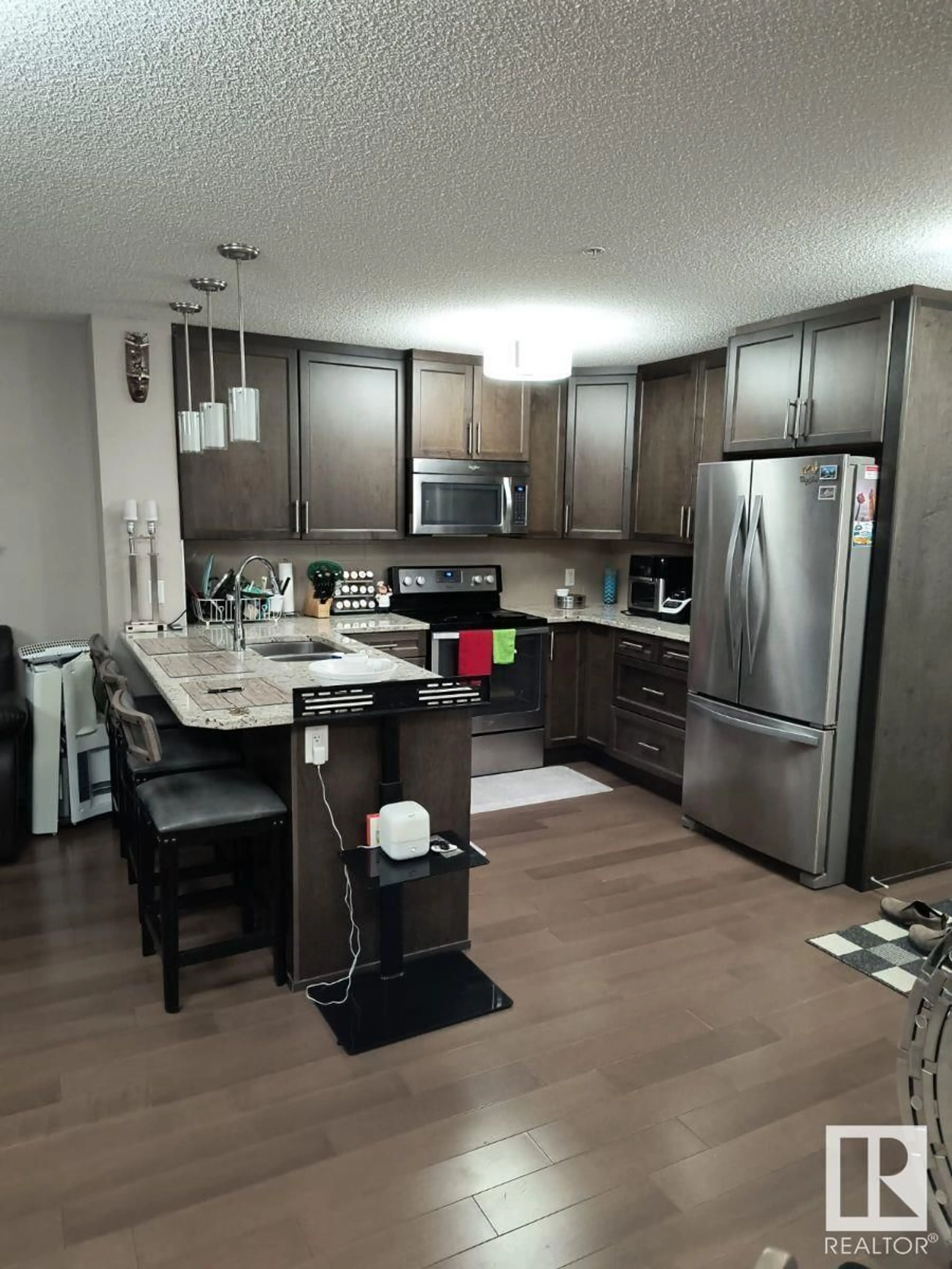 Open concept kitchen for #109 2207 44 AV NW, Edmonton Alberta T6T0T2