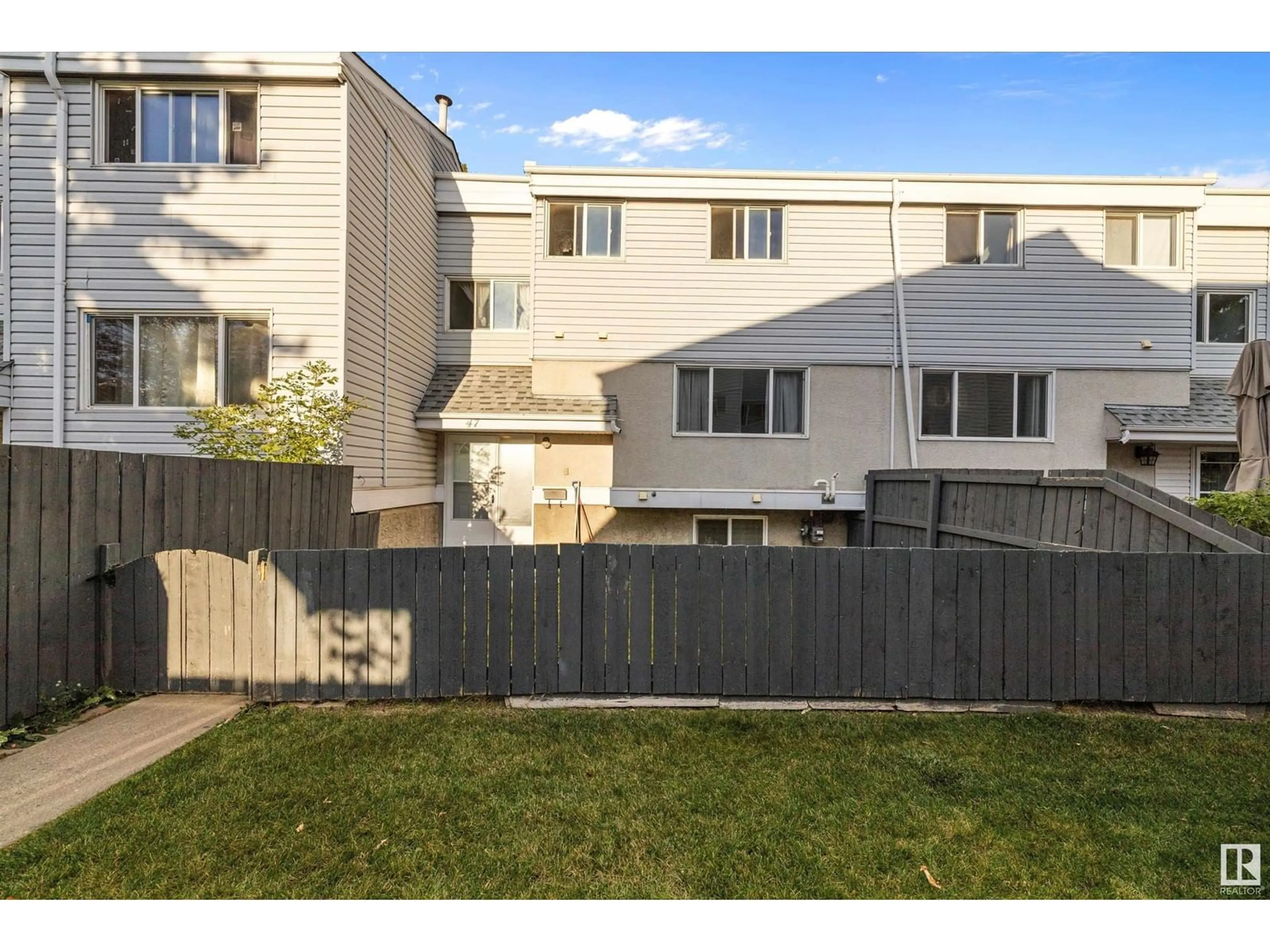 A pic from exterior of the house or condo, the fenced backyard for 47 MCLEOD PL NW, Edmonton Alberta T5A3A8