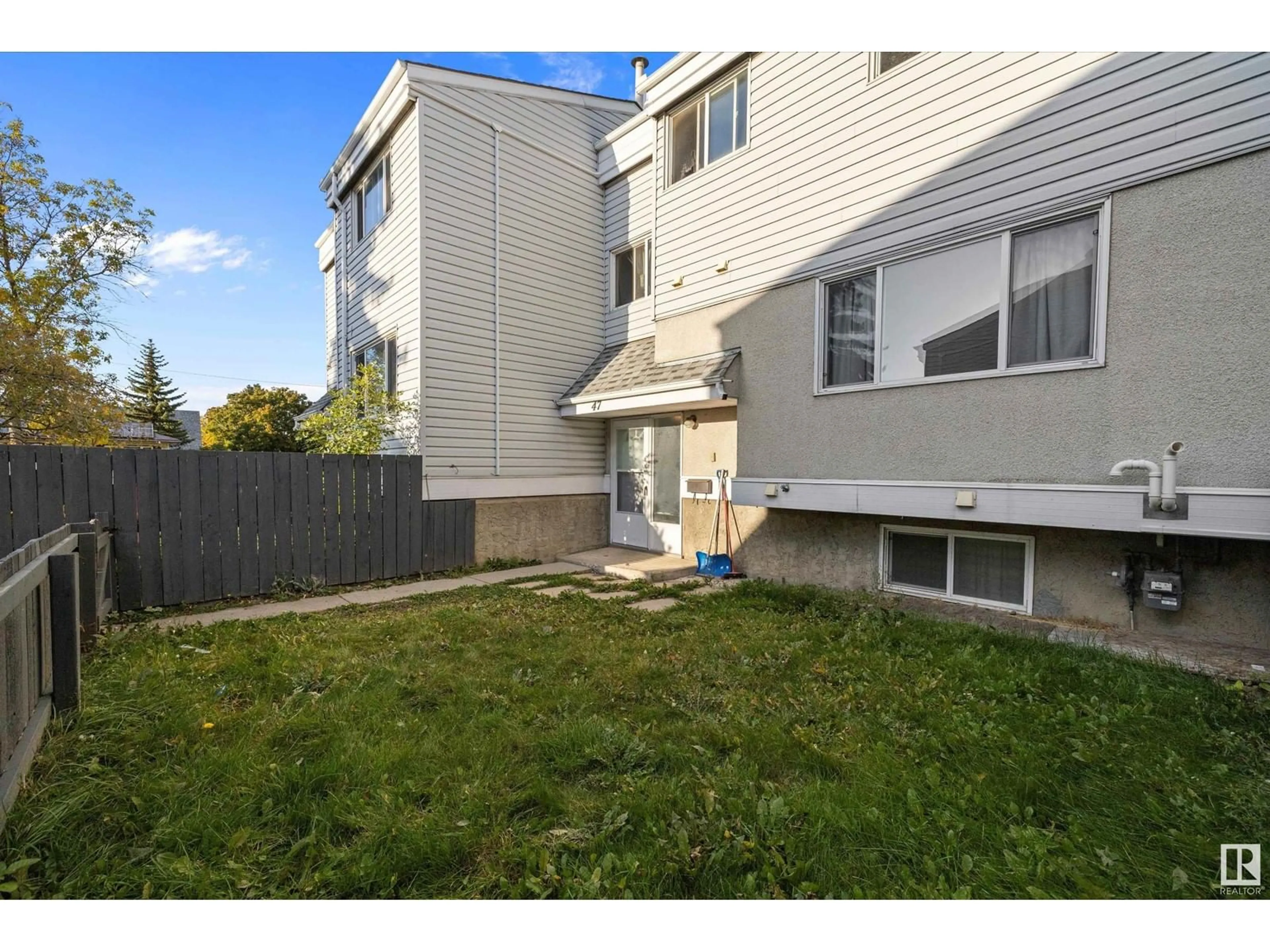 A pic from exterior of the house or condo, the fenced backyard for 47 MCLEOD PL NW, Edmonton Alberta T5A3A8