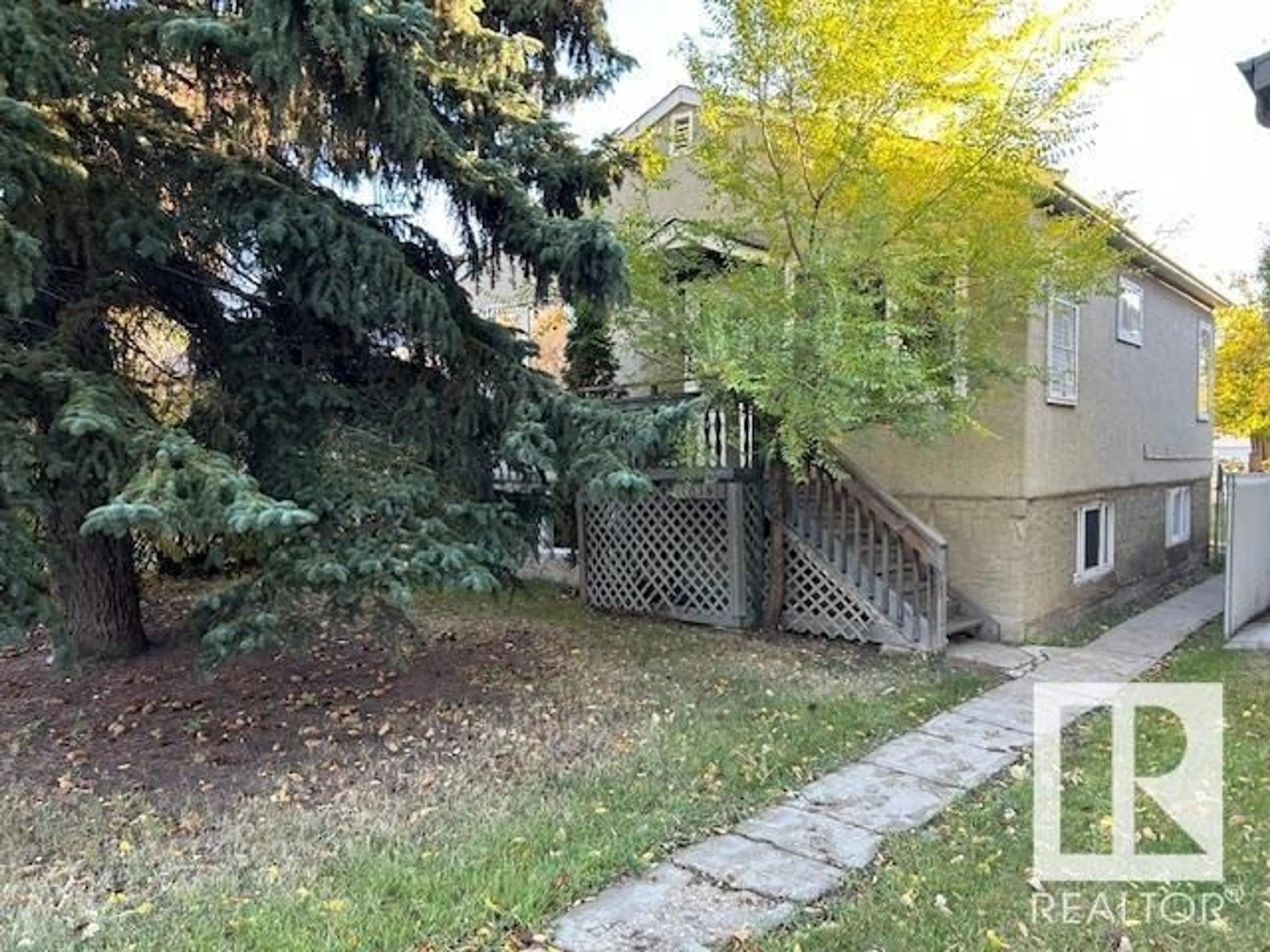 A pic from exterior of the house or condo, the fenced backyard for 10341 149 ST NW, Edmonton Alberta T5P1L4