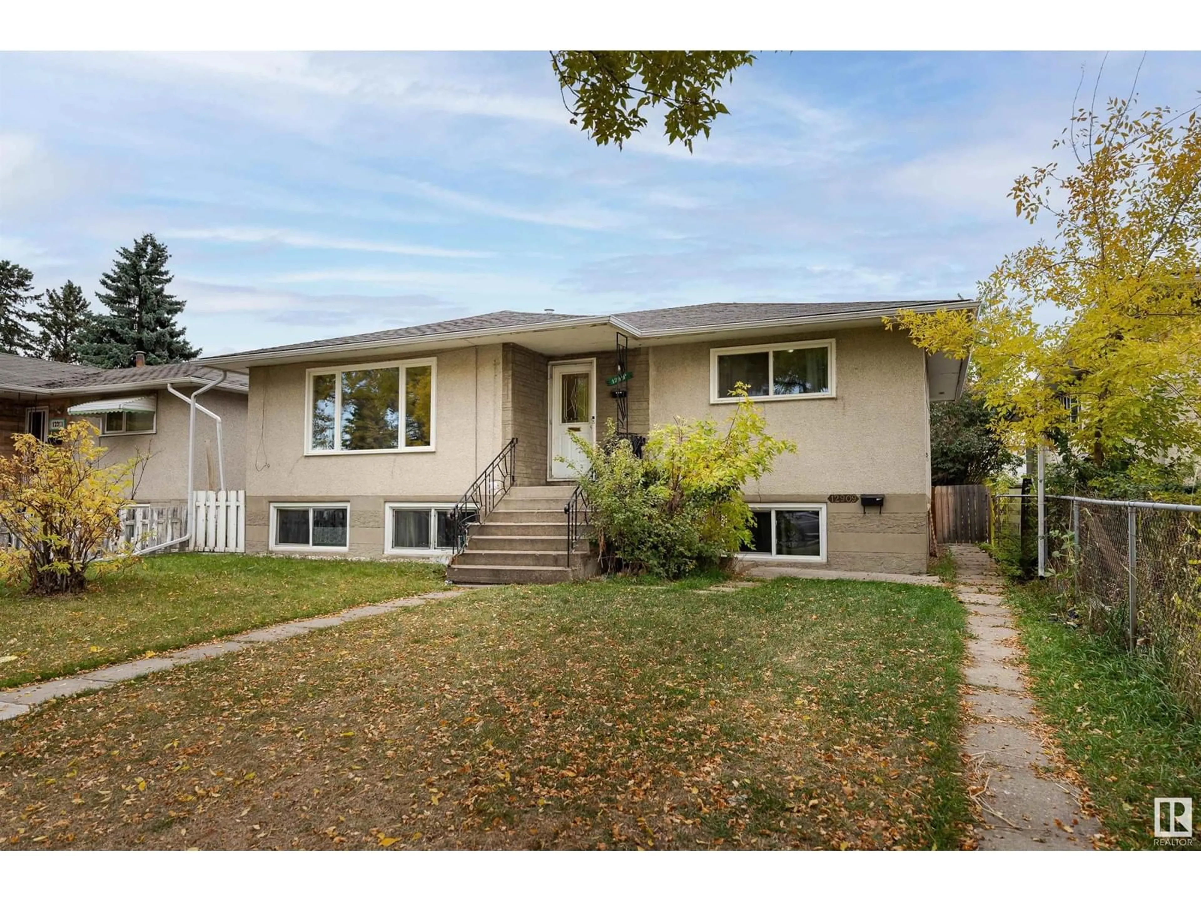 Frontside or backside of a home, the fenced backyard for 12907 102 ST NW, Edmonton Alberta T5E4J4