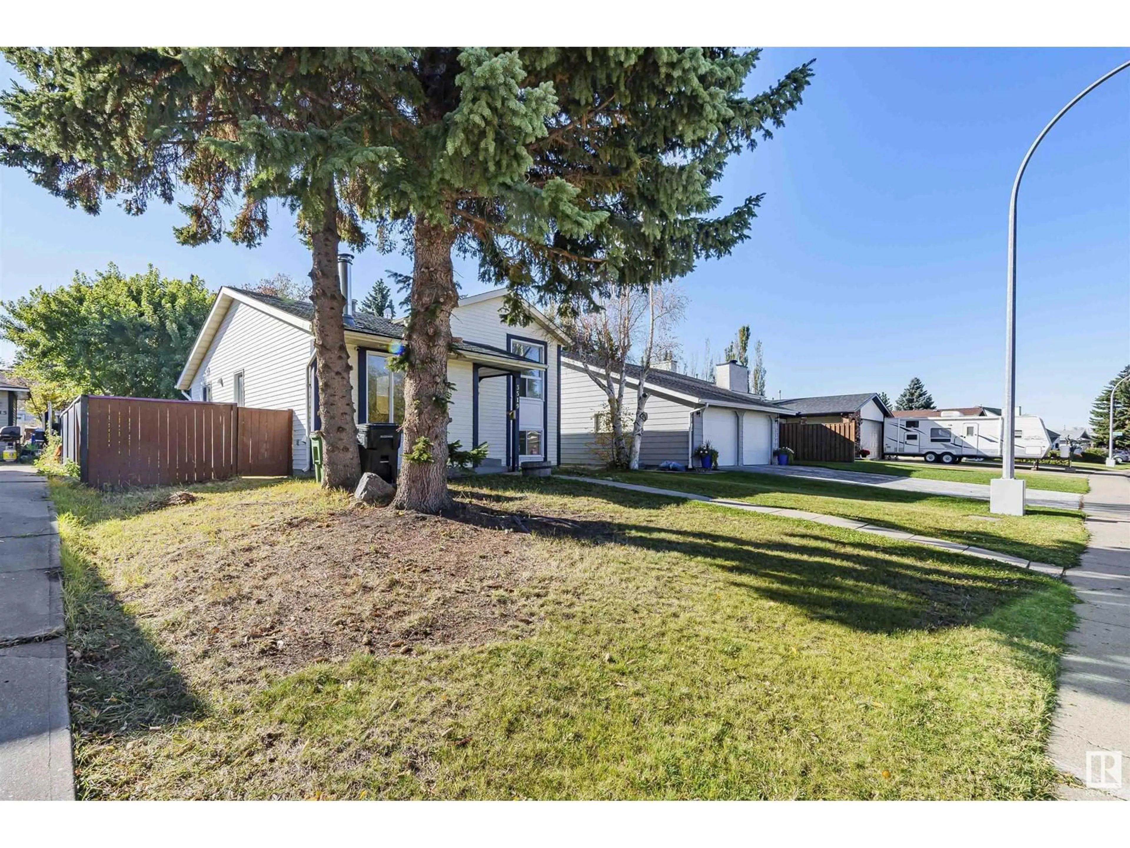 Frontside or backside of a home, the fenced backyard for 3519 13 AV NW, Edmonton Alberta T6L2M1