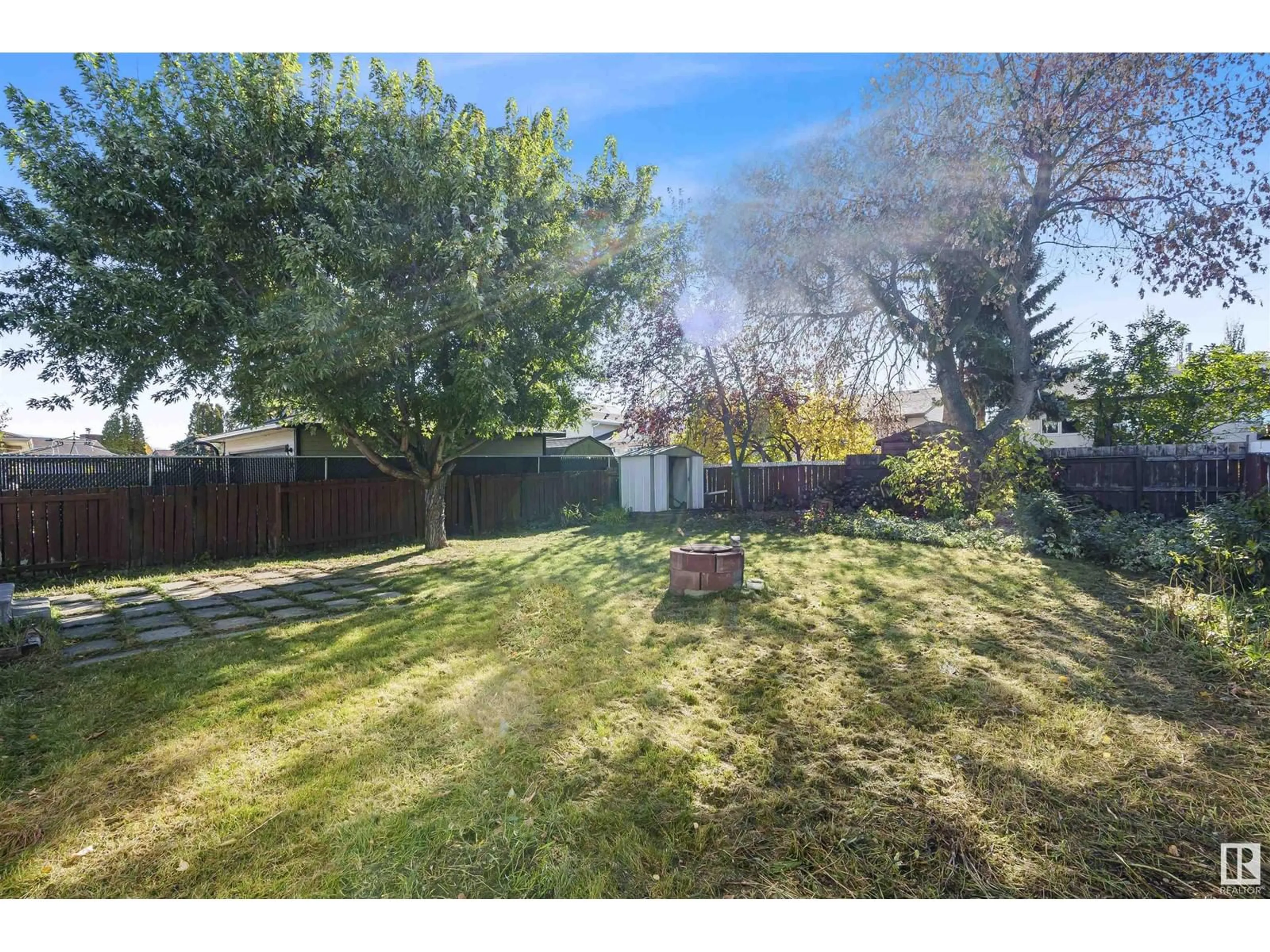 A pic from exterior of the house or condo, the fenced backyard for 3519 13 AV NW, Edmonton Alberta T6L2M1