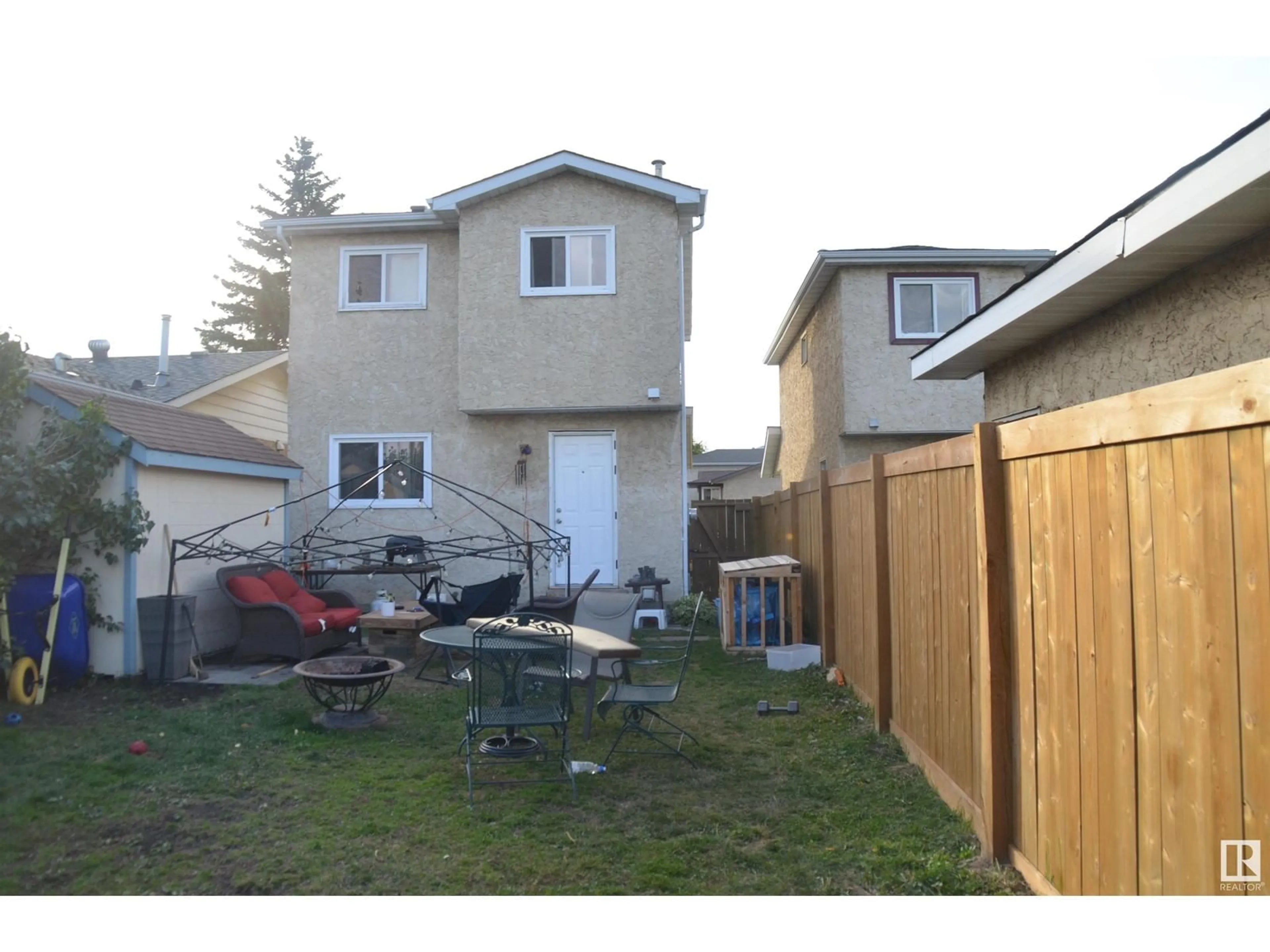 Frontside or backside of a home, the fenced backyard for 4211 35 ST NW, Edmonton Alberta T6L5A3