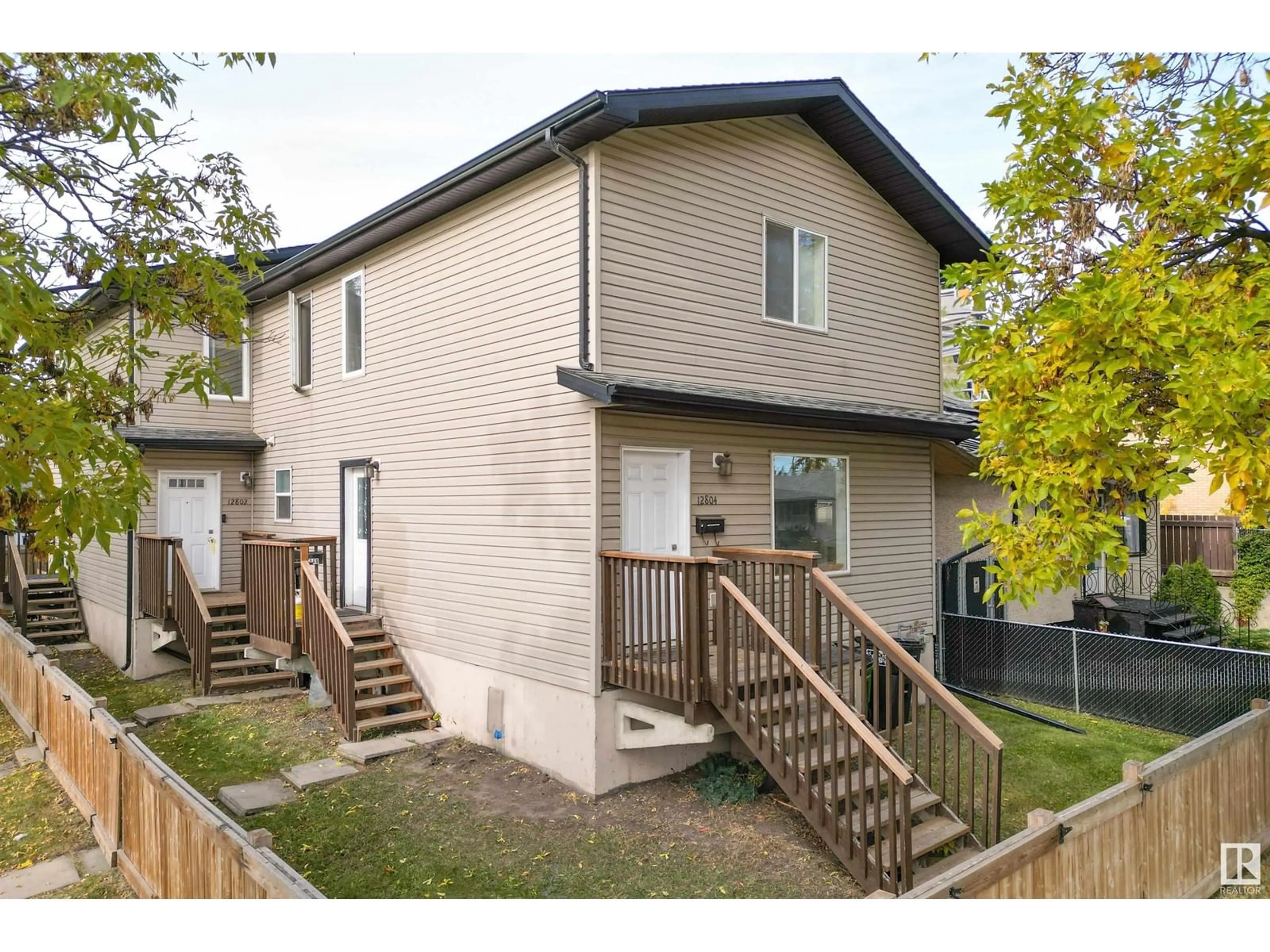 A pic from exterior of the house or condo, the fenced backyard for 12802-12804 71 ST NW, Edmonton Alberta T5C0M2