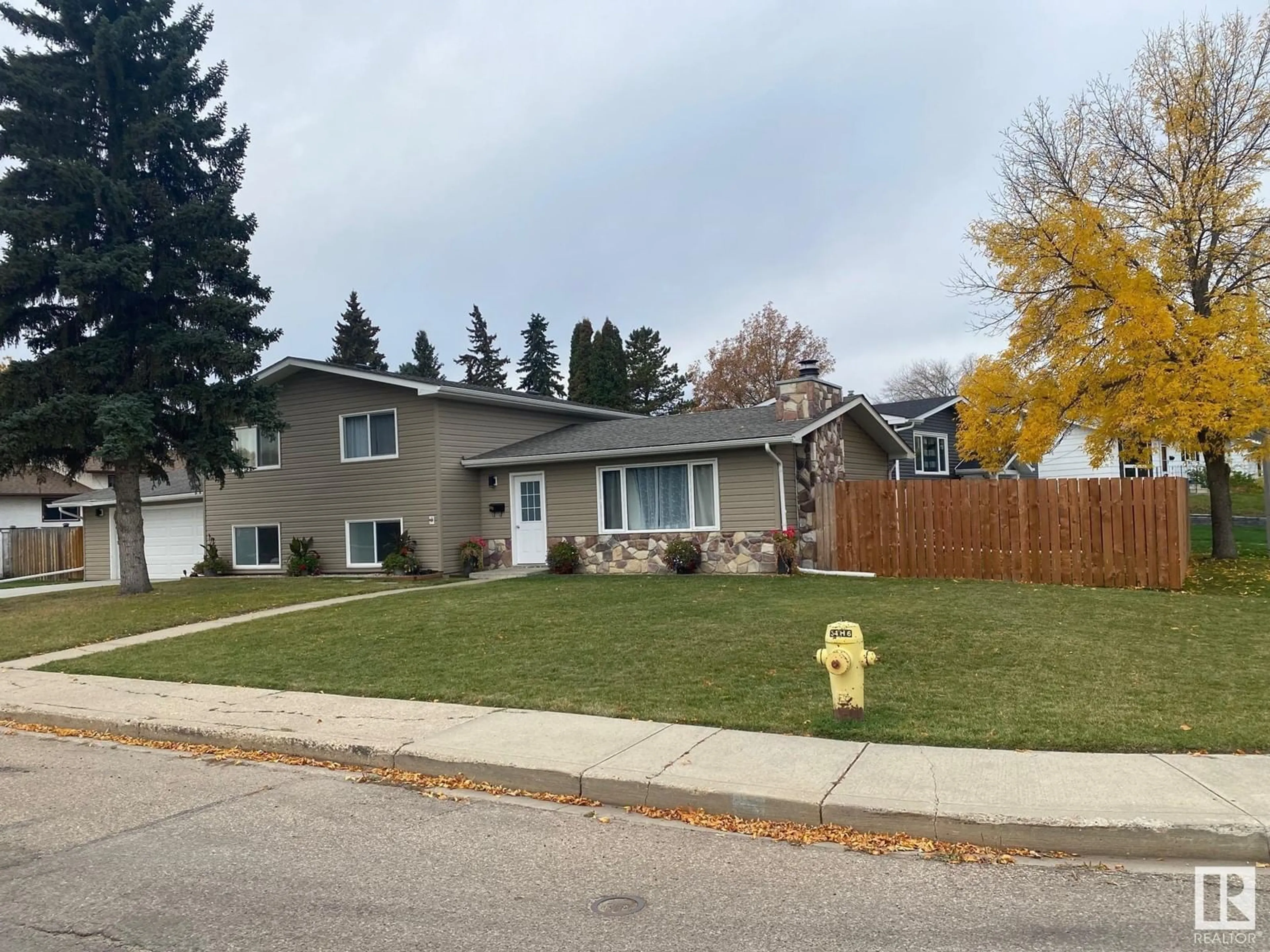 Frontside or backside of a home, the fenced backyard for 104 OAK DR, Wetaskiwin Alberta T9A2E7