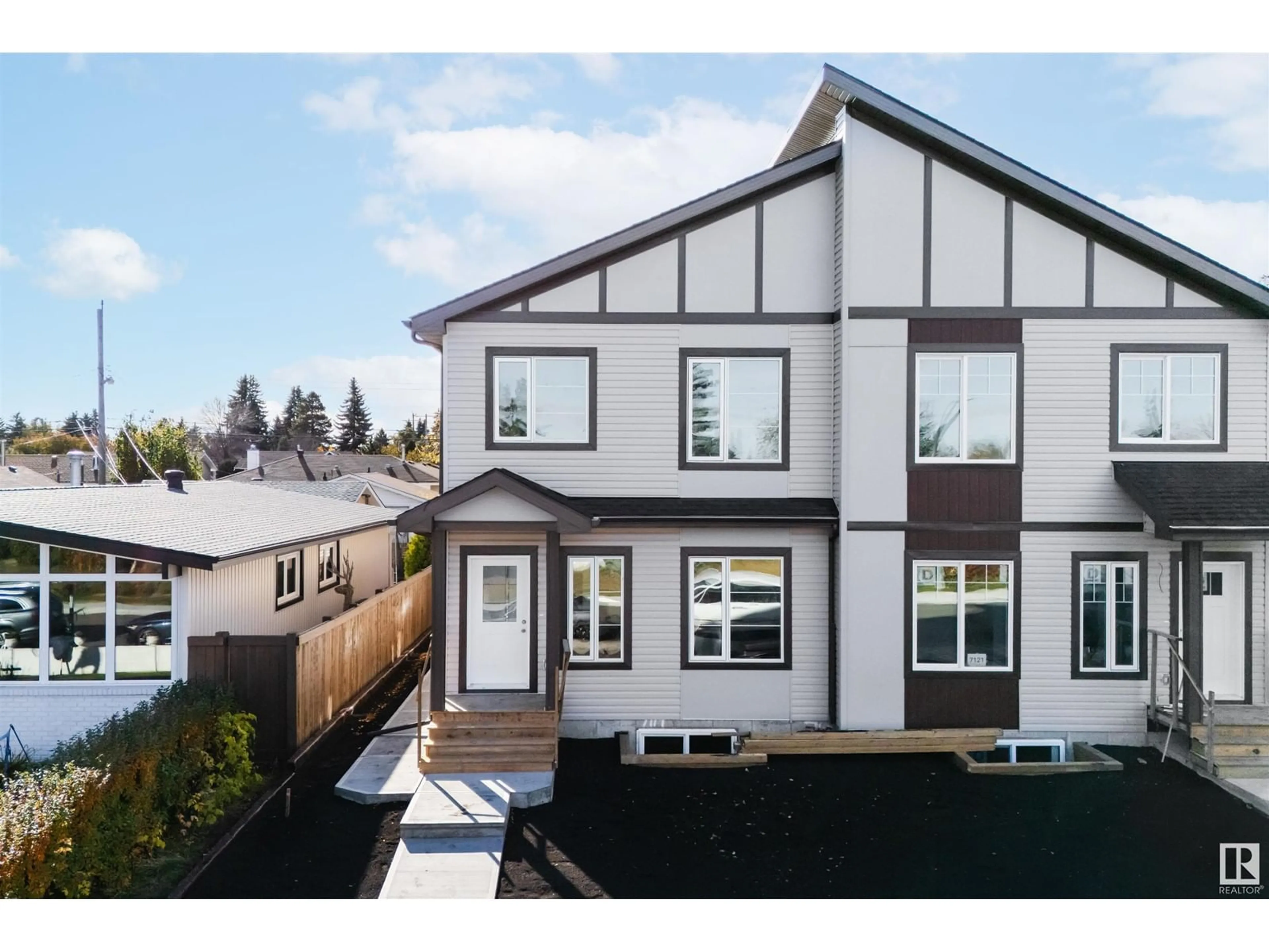 Frontside or backside of a home, the fenced backyard for 7119 93 AV NW, Edmonton Alberta T6B0W7