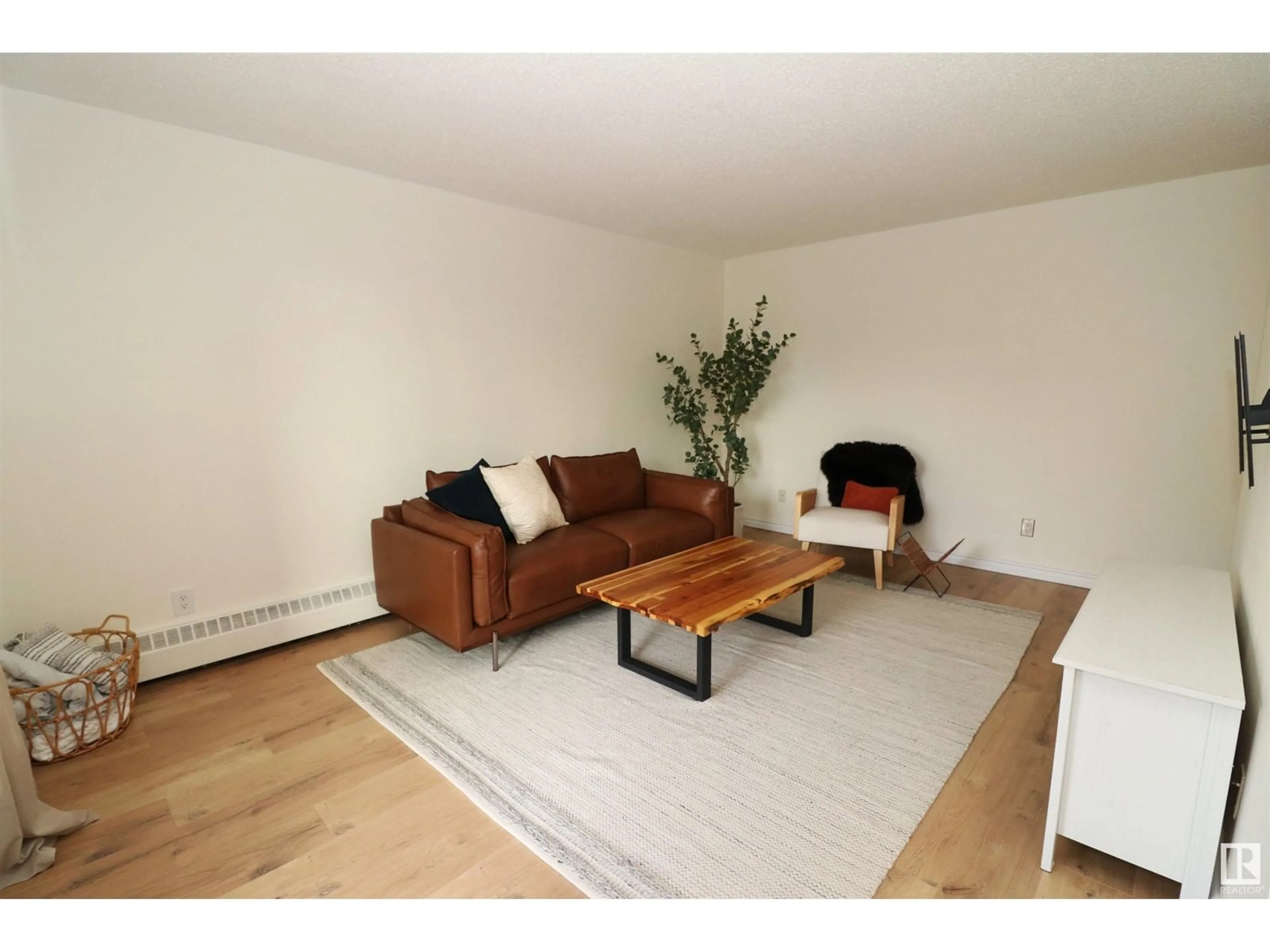 Living room, wood floors for #105 8814 95 AV NW, Edmonton Alberta T6C1Z1