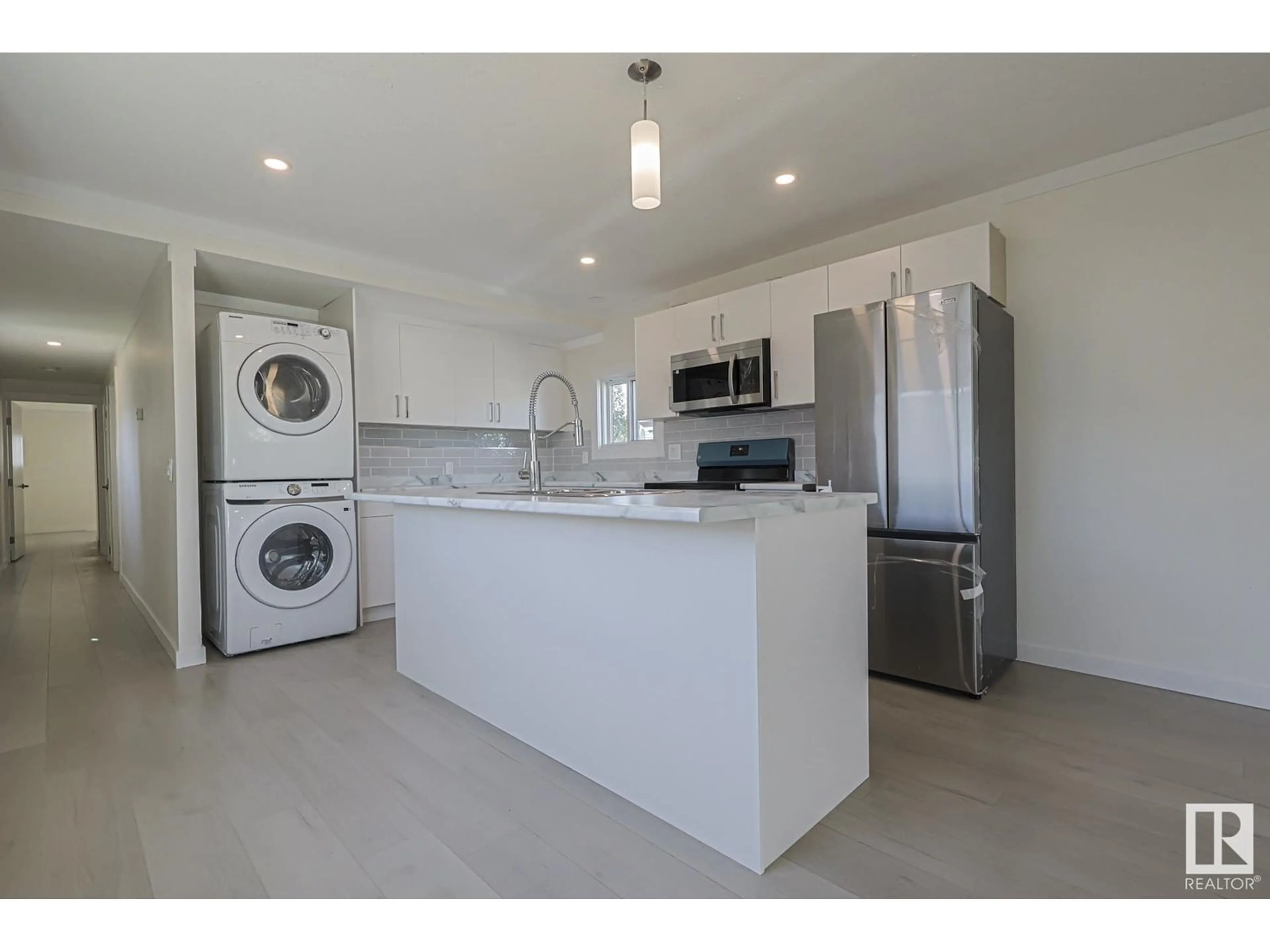 Kitchen with laundary machines, wood floors for 53 West View BLVD NW, Edmonton Alberta T5S1T5