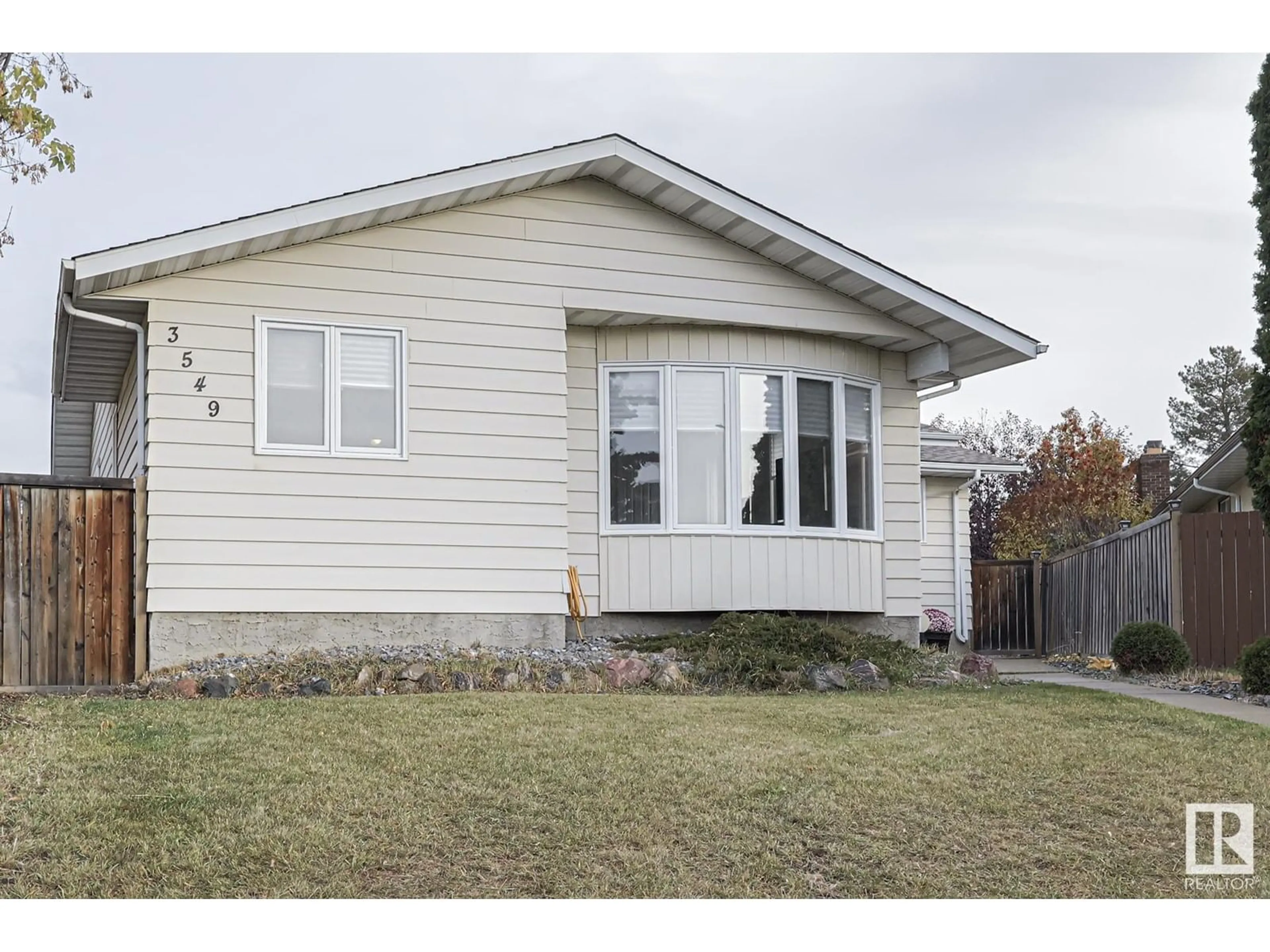 Frontside or backside of a home, the fenced backyard for 3549 61 ST NW, Edmonton Alberta T6L1H1