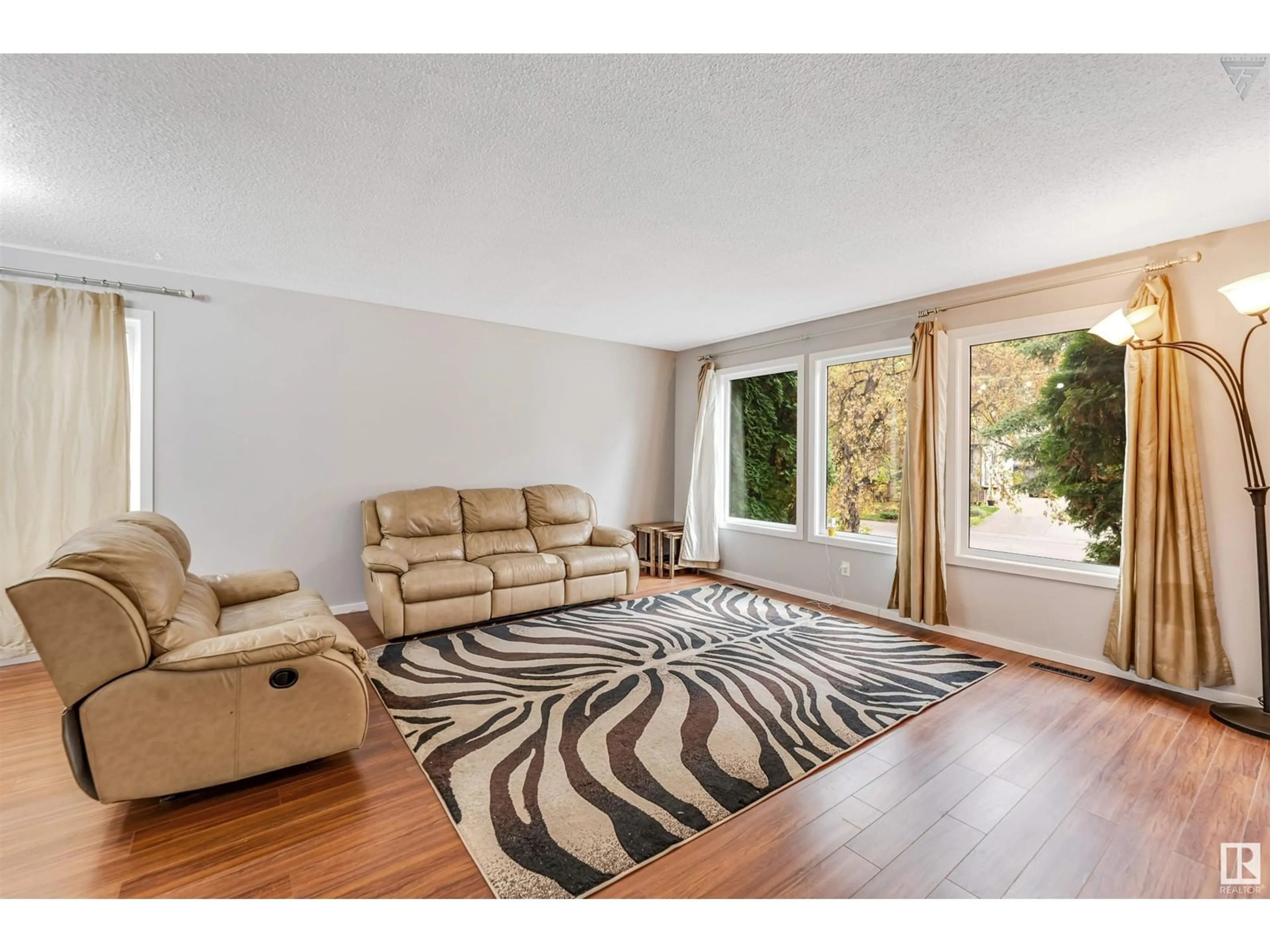 Living room, wood floors for 6416 11 AV NW, Edmonton Alberta T6L2G4