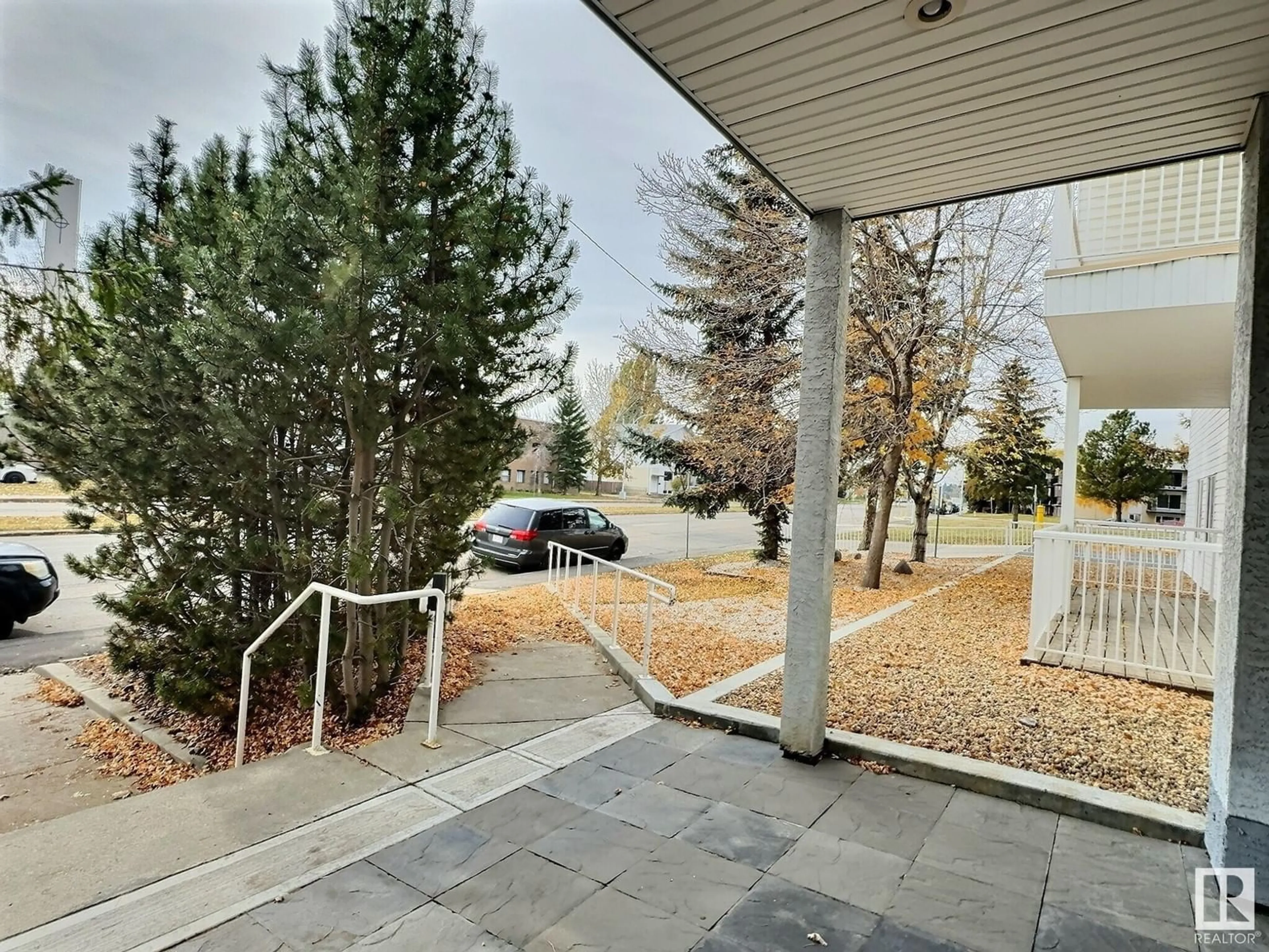 A pic from exterior of the house or condo, the fenced backyard for #205 11446 40 AV NW, Edmonton Alberta T6J0R5