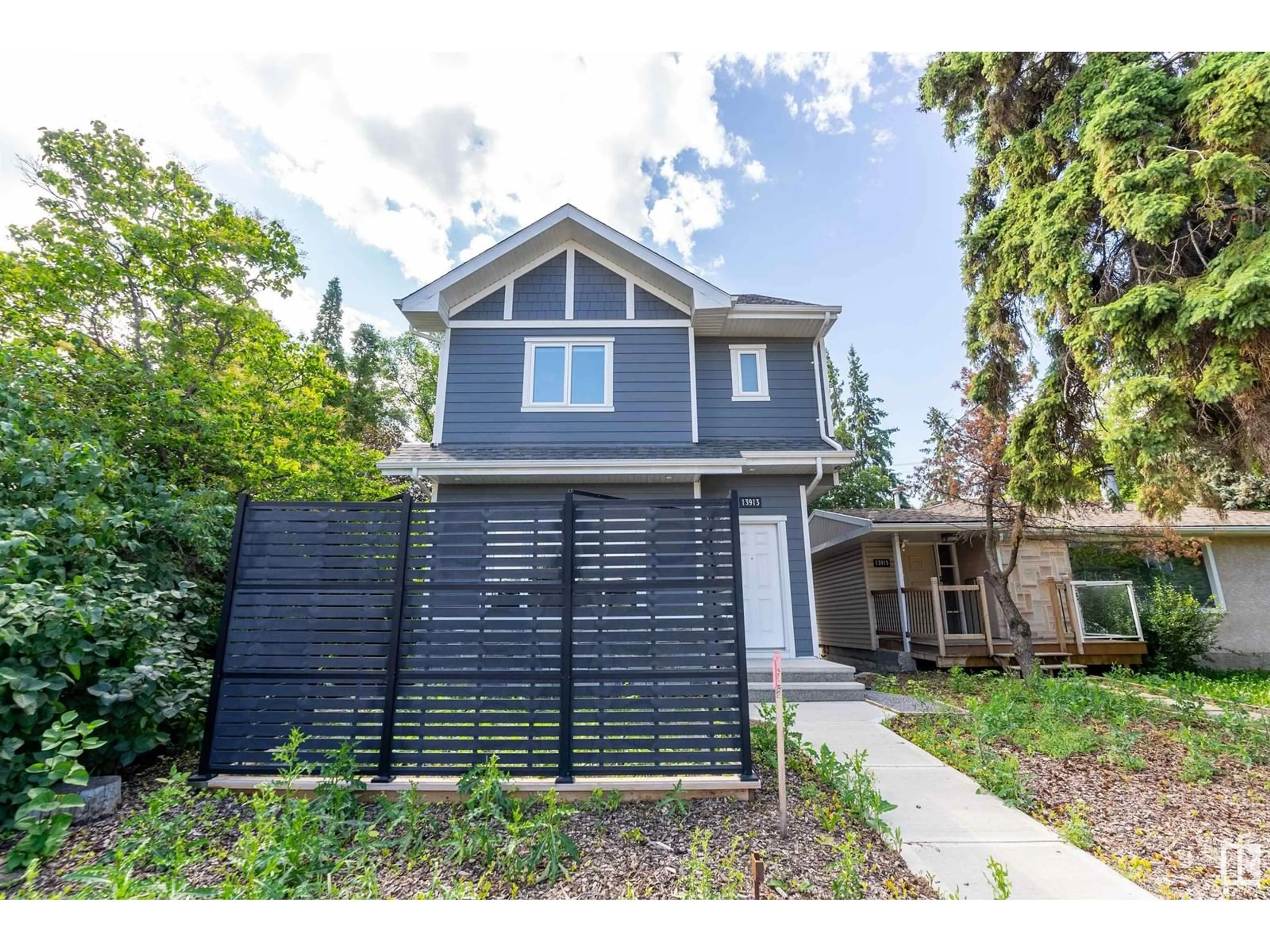 Frontside or backside of a home, the fenced backyard for 13913 102 AV NW, Edmonton Alberta T5N0P5