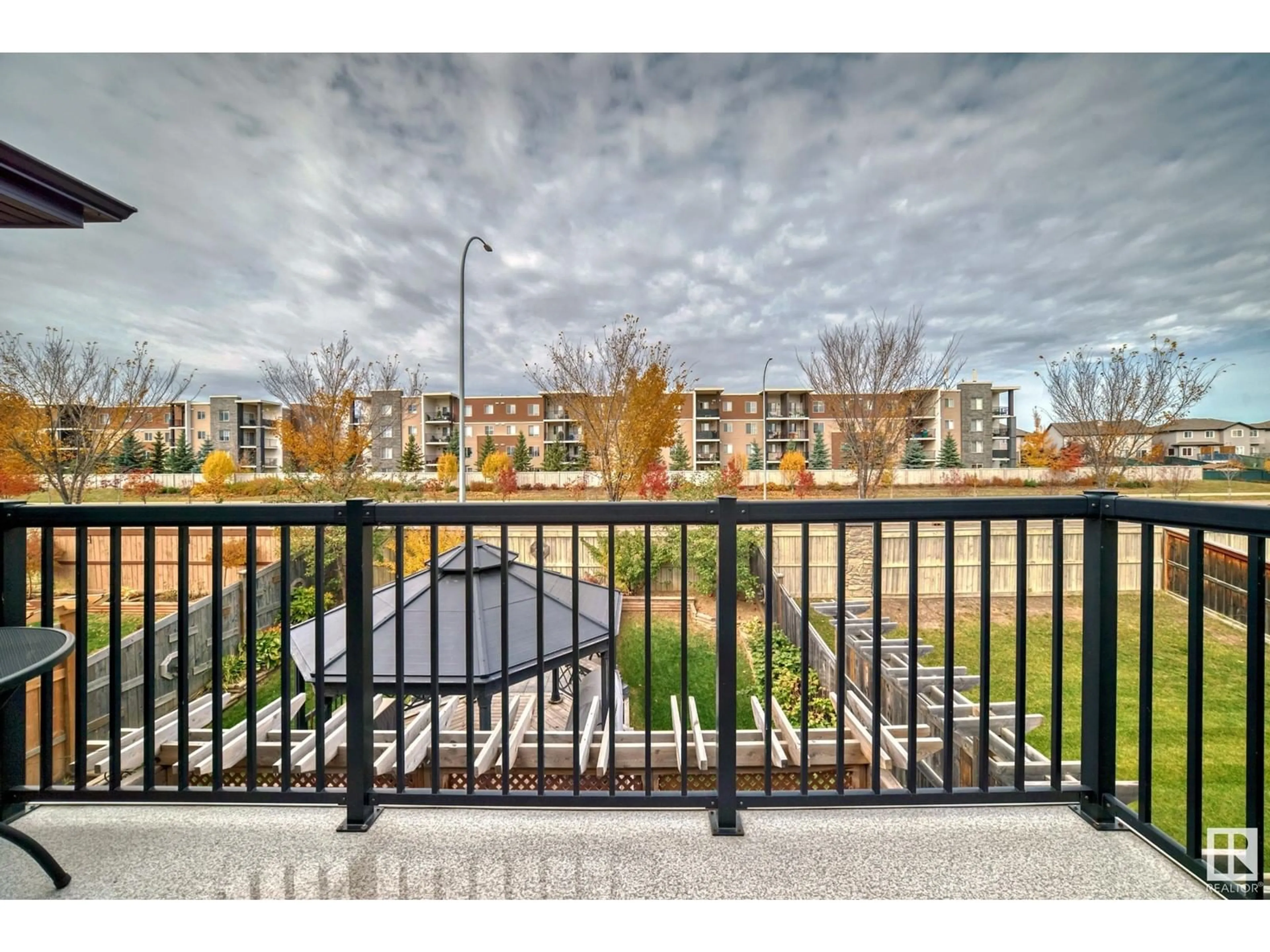 A pic from exterior of the house or condo, the fenced backyard for 1528 Cunningham Cape SW, Edmonton Alberta T6W0Y3