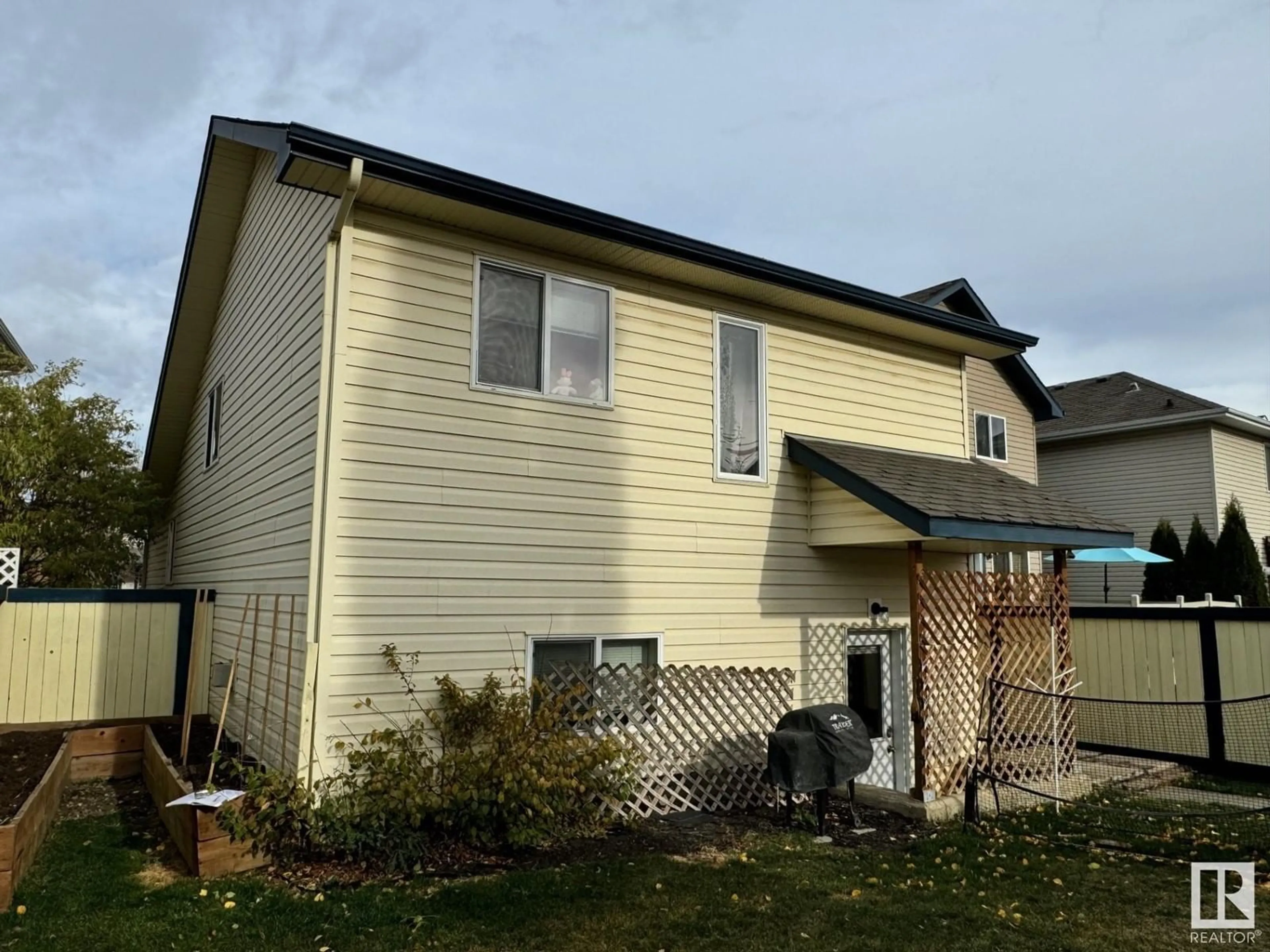 Frontside or backside of a home, the fenced backyard for 21315 91 AV NW, Edmonton Alberta T5T6Y9