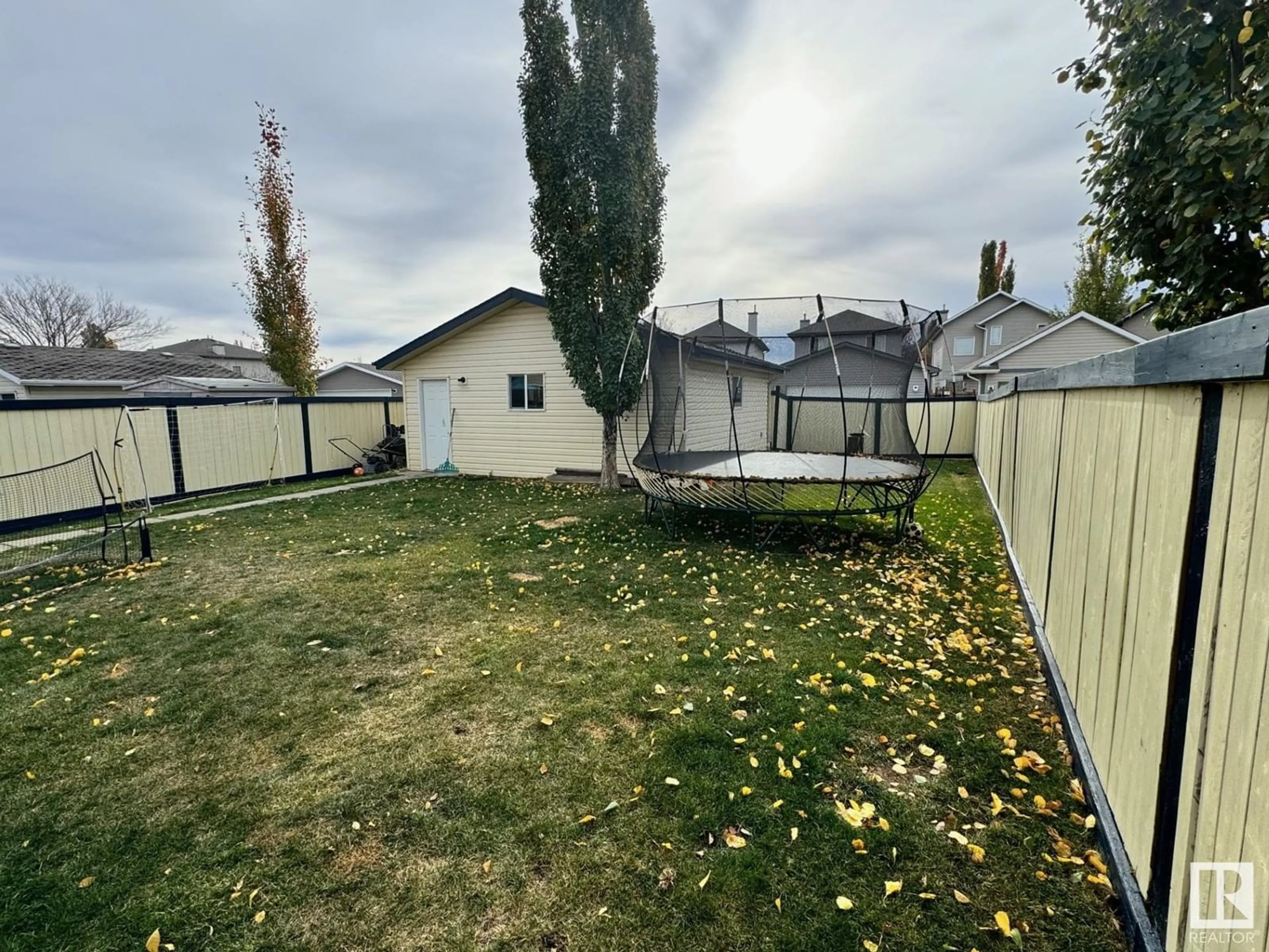 Frontside or backside of a home, the fenced backyard for 21315 91 AV NW, Edmonton Alberta T5T6Y9