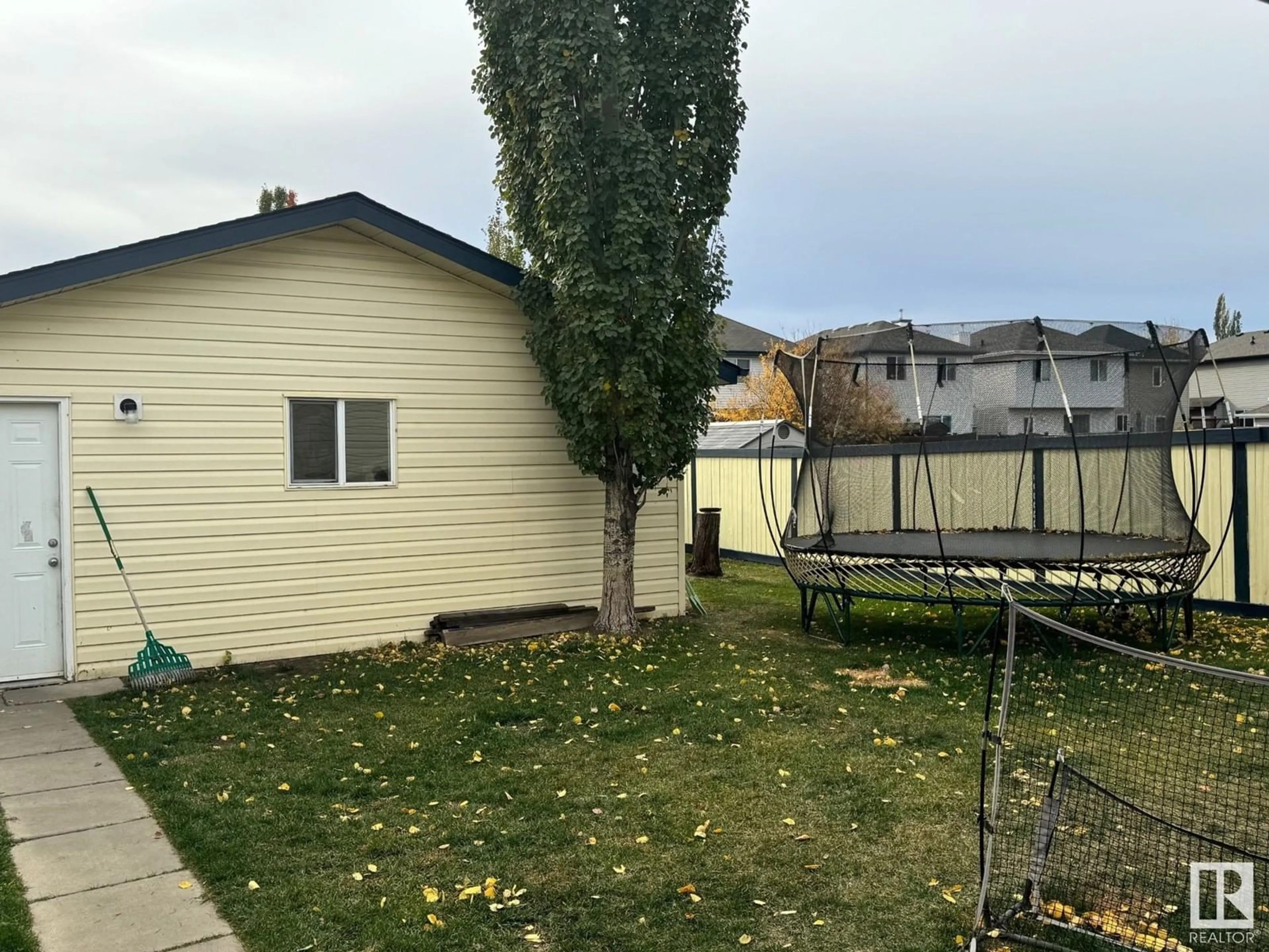 Frontside or backside of a home, the fenced backyard for 21315 91 AV NW, Edmonton Alberta T5T6Y9