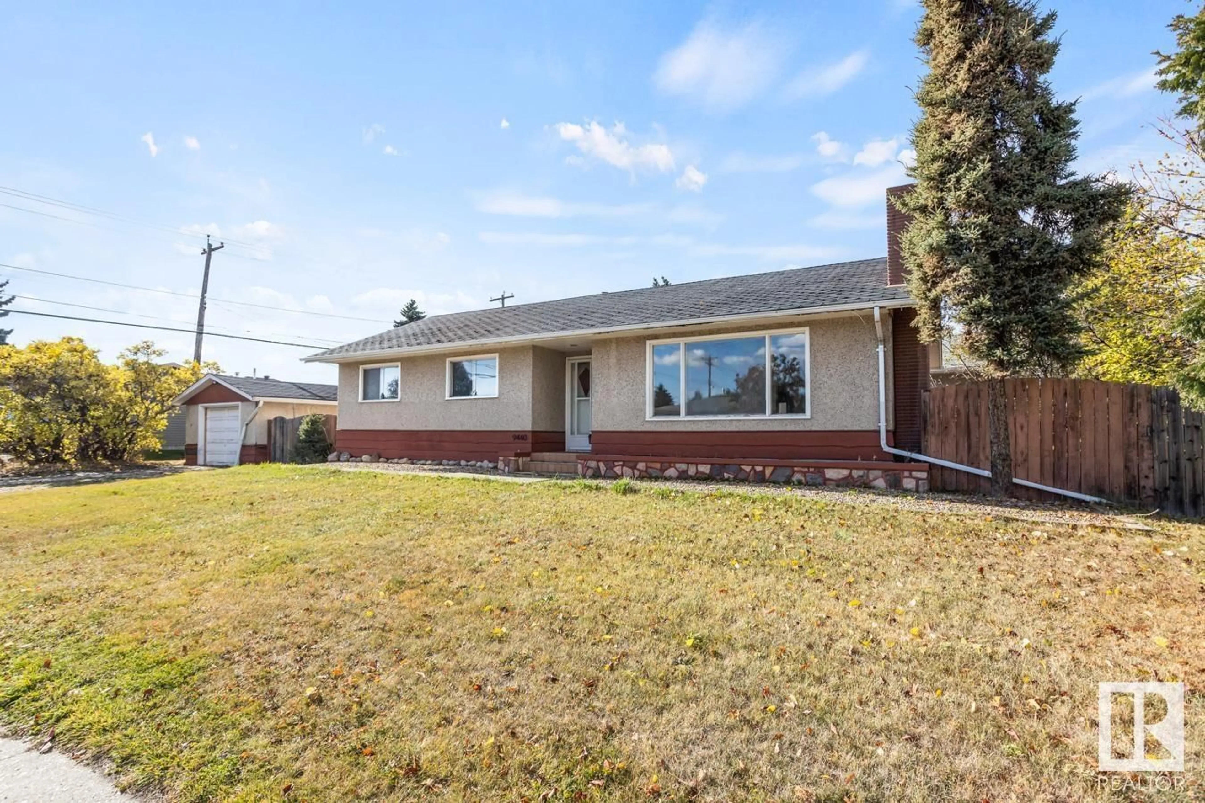 Frontside or backside of a home, the fenced backyard for 9440 57 ST NW, Edmonton Alberta T6B1J9