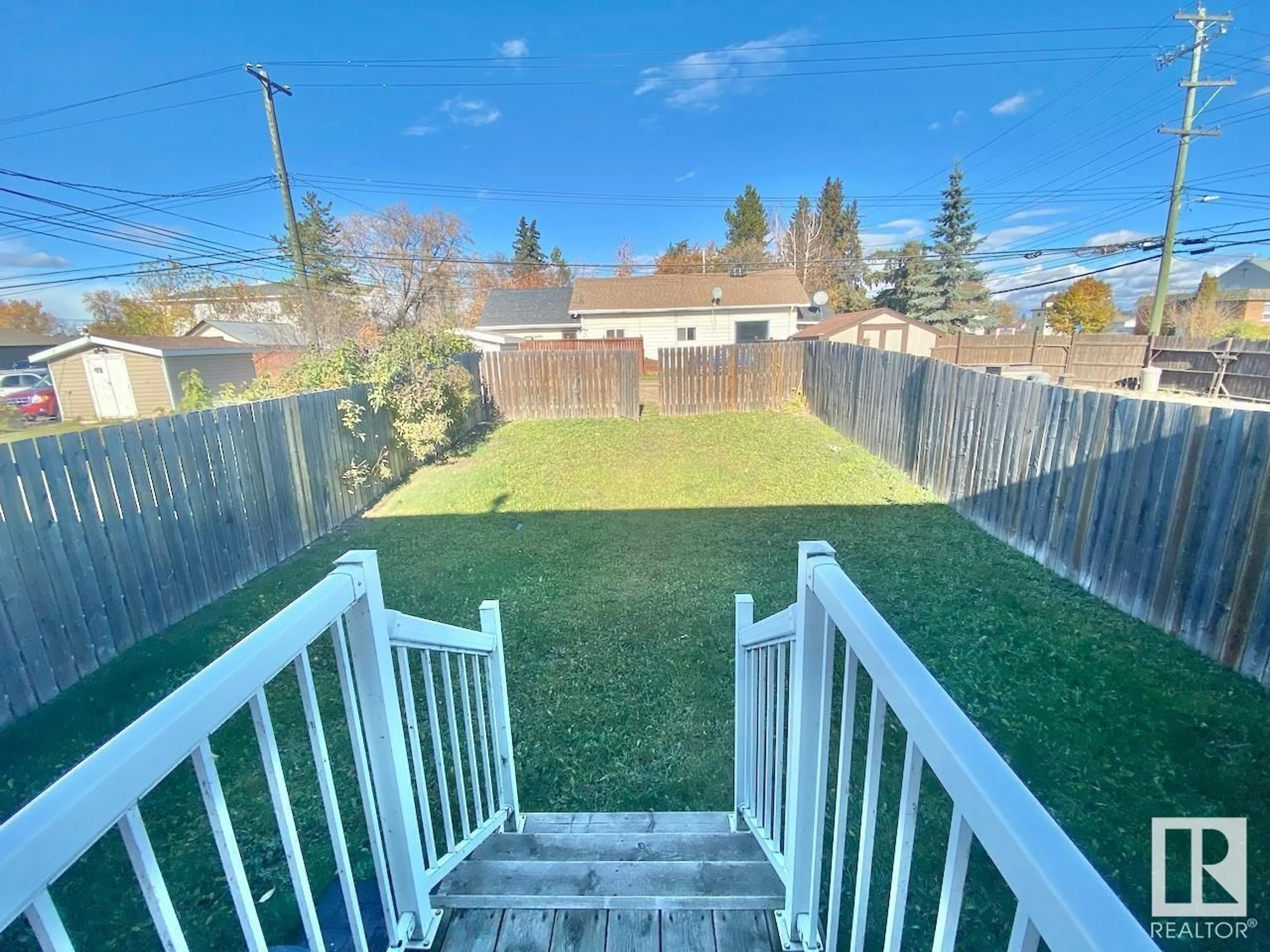 Frontside or backside of a home, the fenced backyard for 5104 51 AV, St. Paul Town Alberta T0A3A0