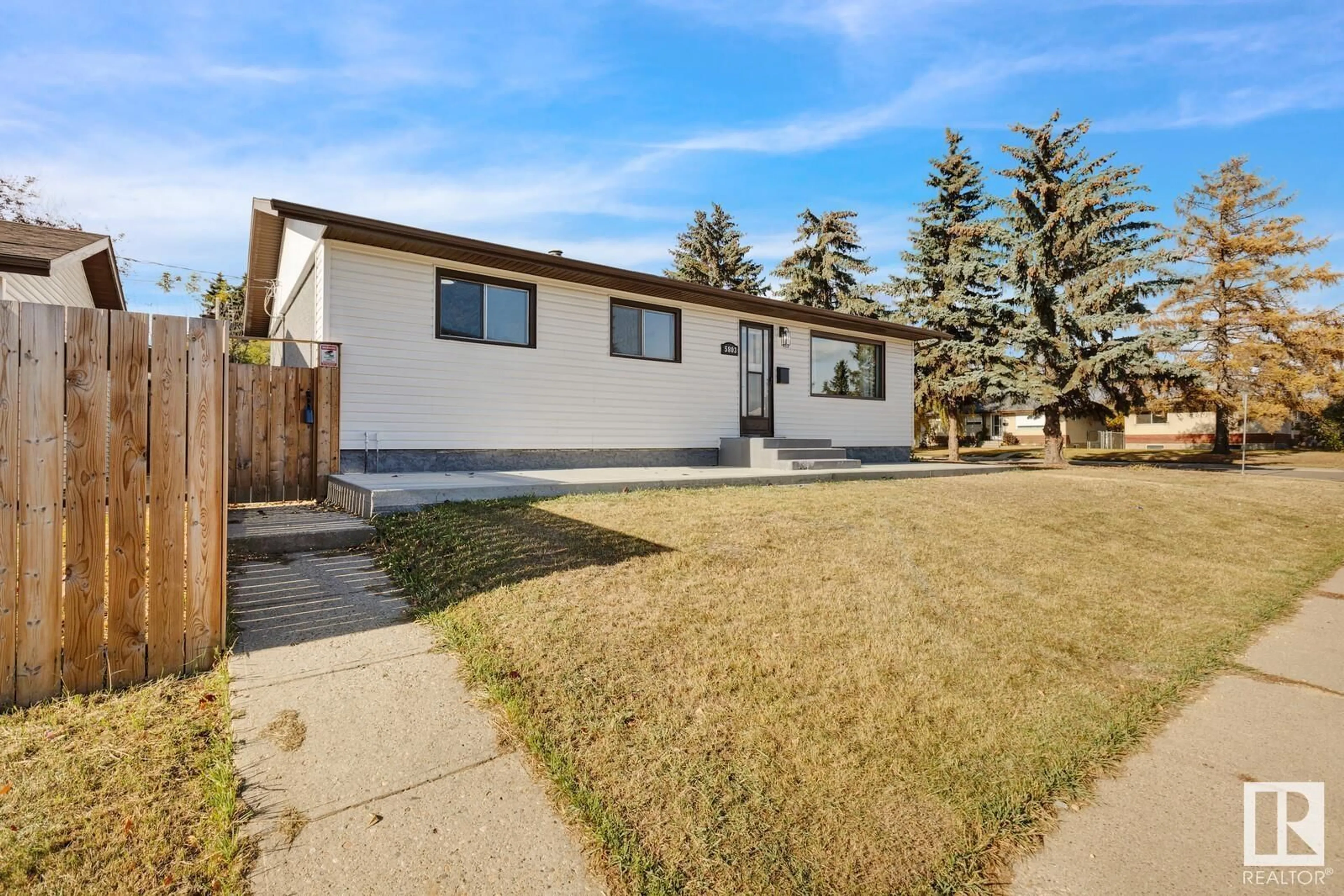 A pic from exterior of the house or condo, the fenced backyard for 5803 136 AV NW NW, Edmonton Alberta T5A0N4