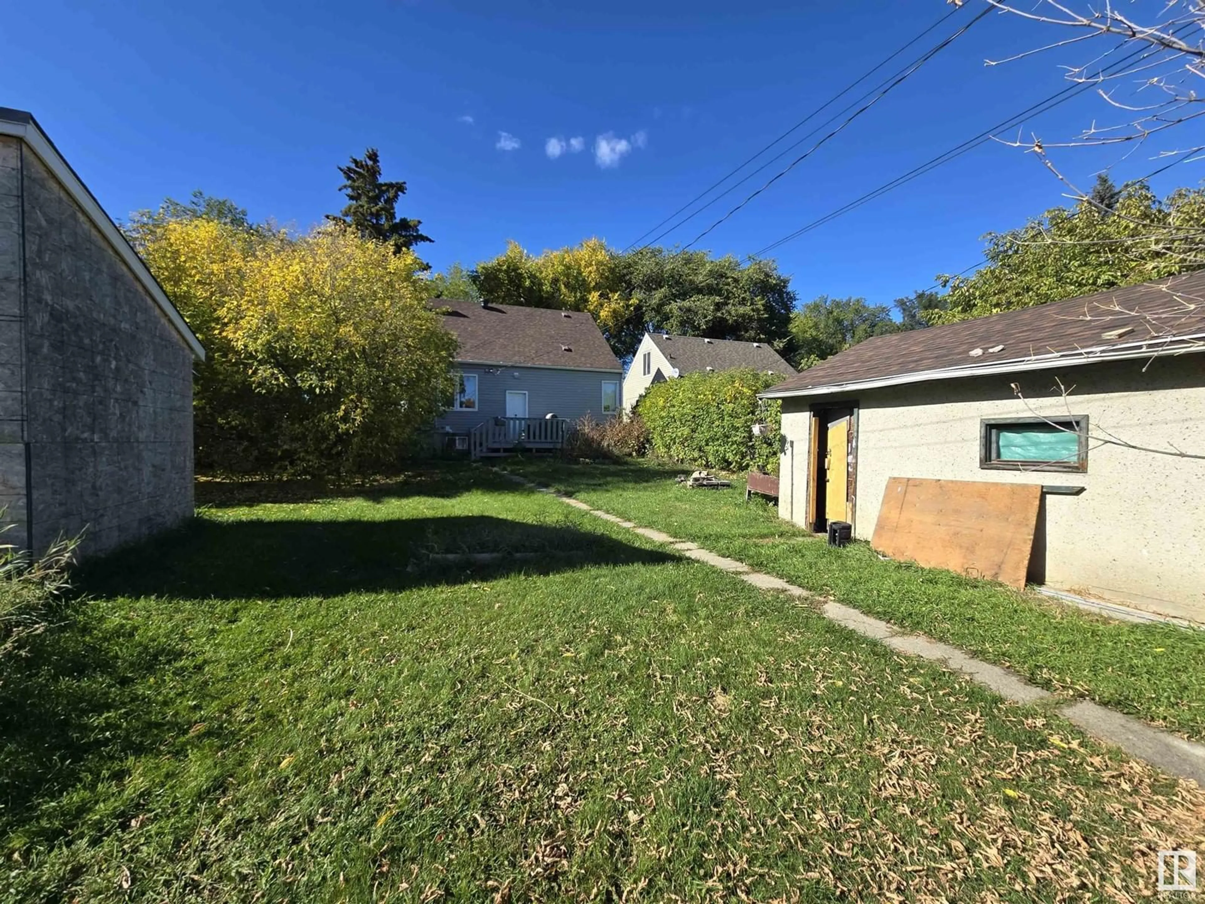 Frontside or backside of a home, the fenced backyard for 12311 104 ST NW, Edmonton Alberta T6G2L9