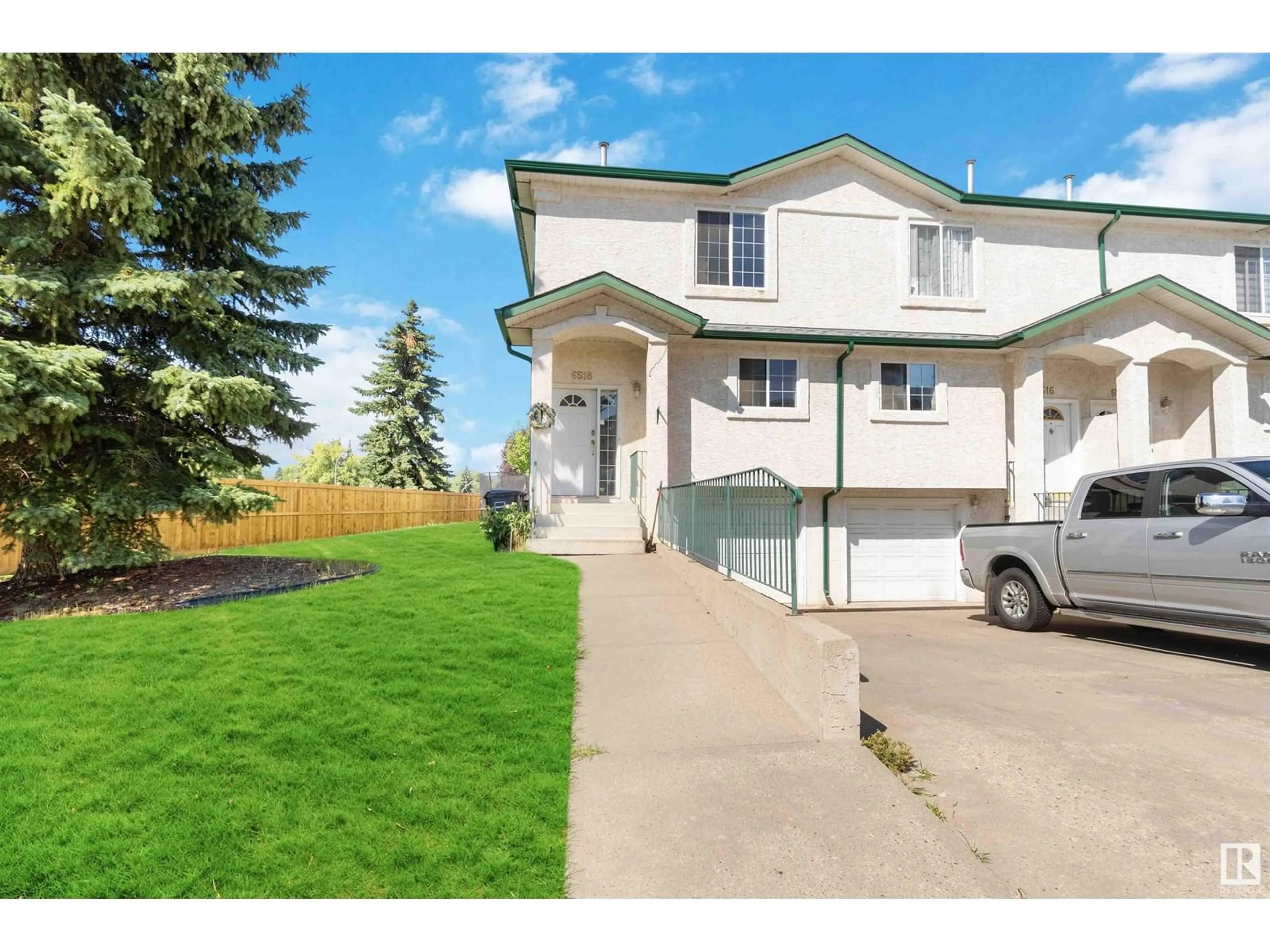 A pic from exterior of the house or condo, the fenced backyard for 6518 19 AV NW, Edmonton Alberta T6L7A2