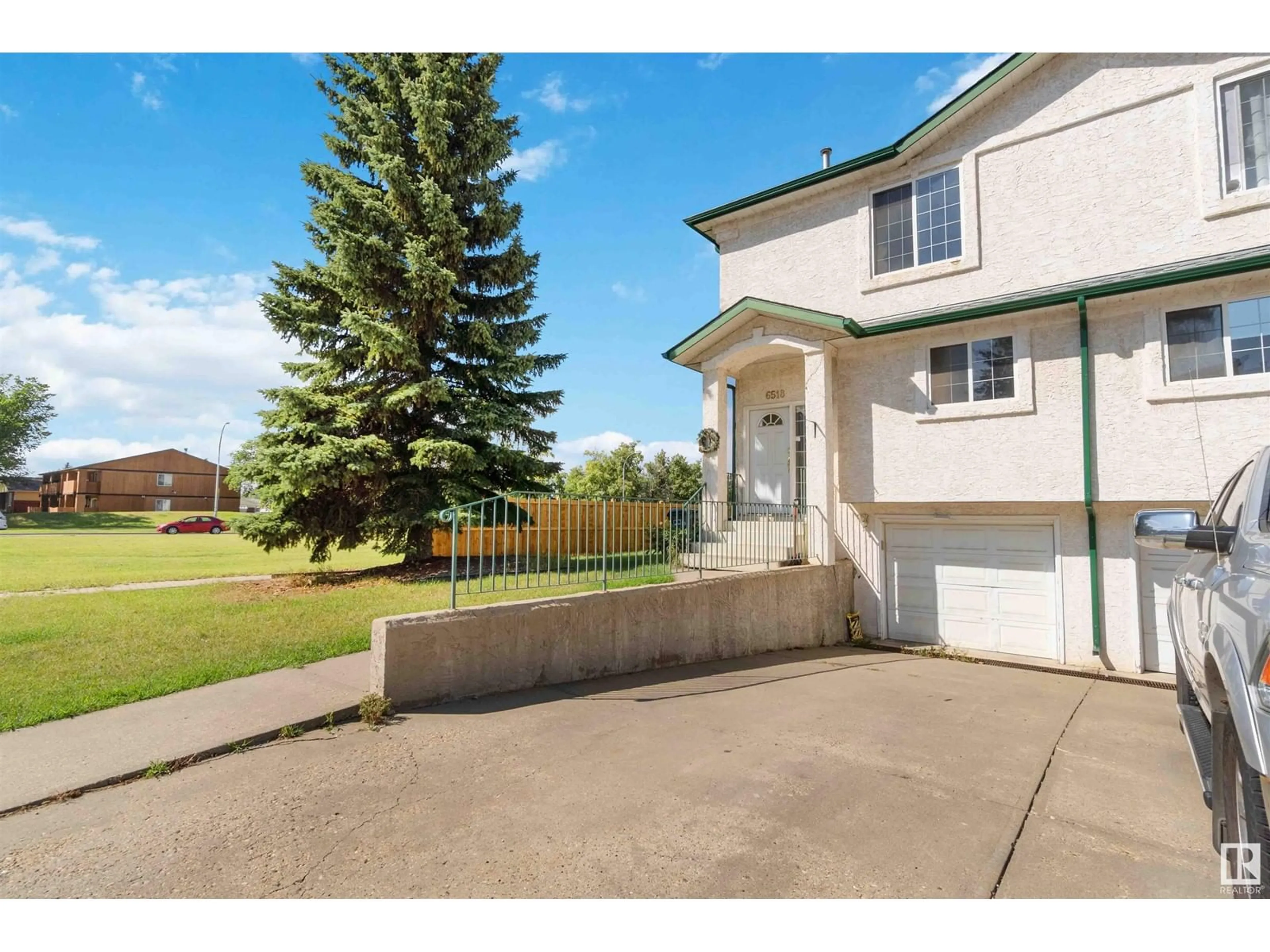 Frontside or backside of a home, the fenced backyard for 6518 19 AV NW, Edmonton Alberta T6L7A2