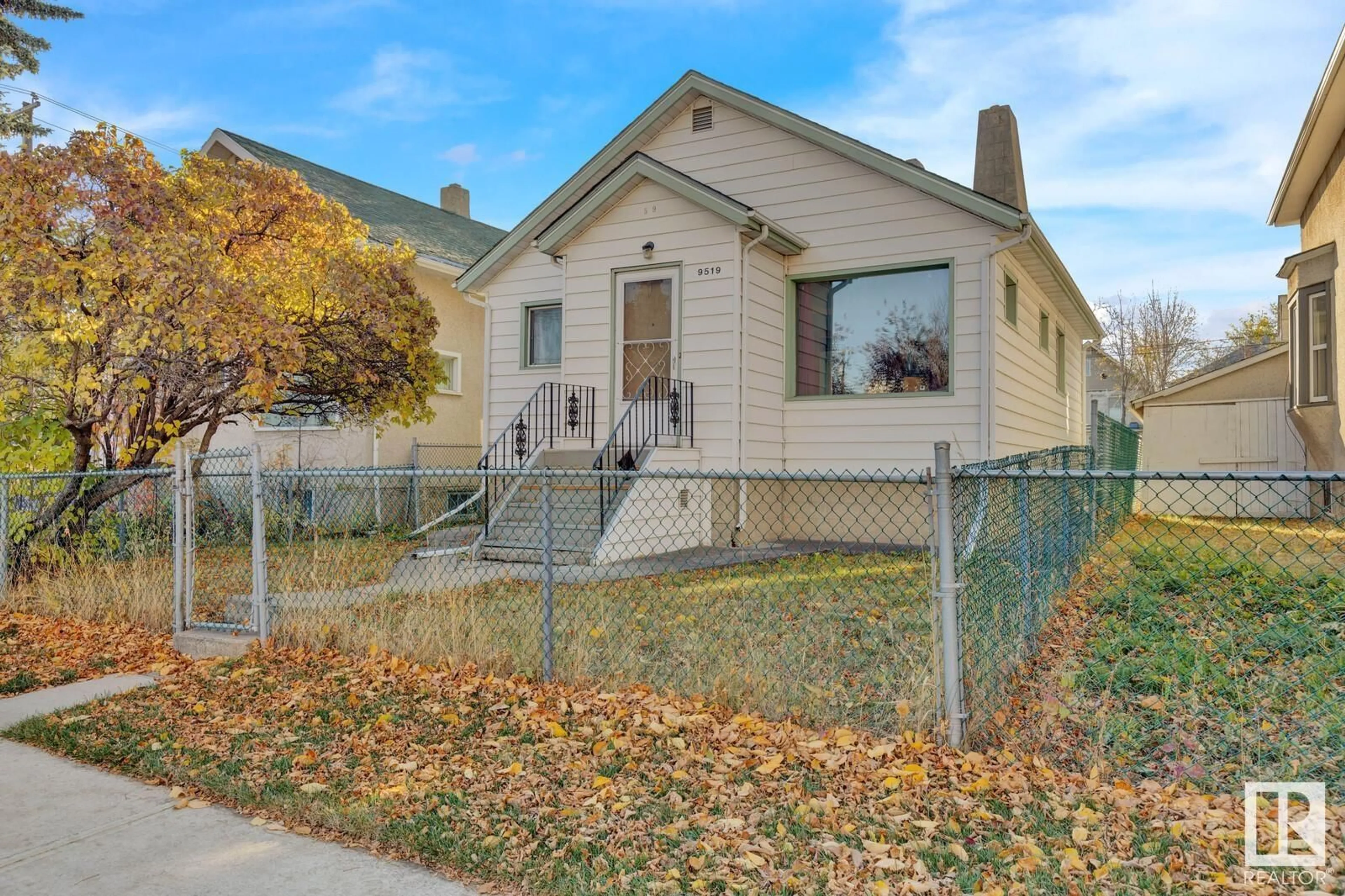 Frontside or backside of a home, the fenced backyard for 9519 107 AV NW, Edmonton Alberta T5H0T6