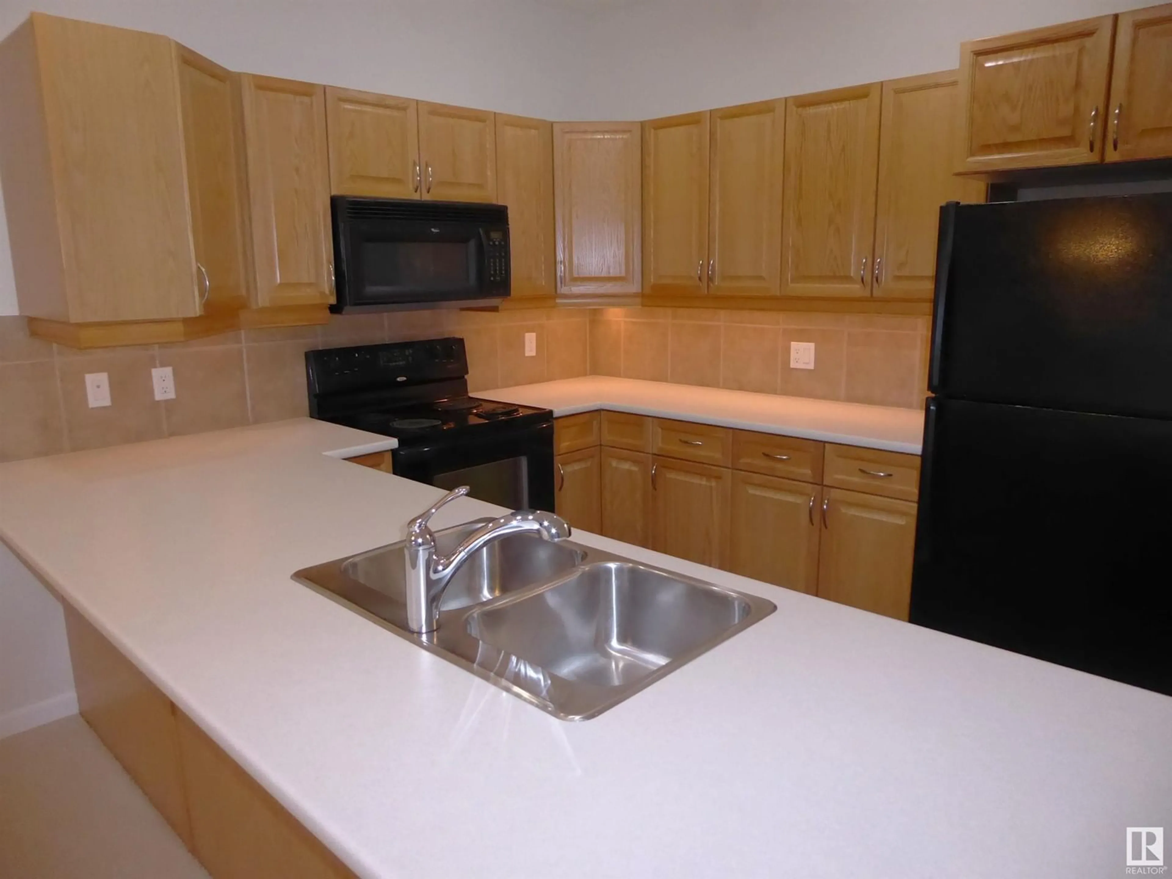 Standard kitchen, wood floors for #201 160 Magrath RD NW NW, Edmonton Alberta T6R3T7