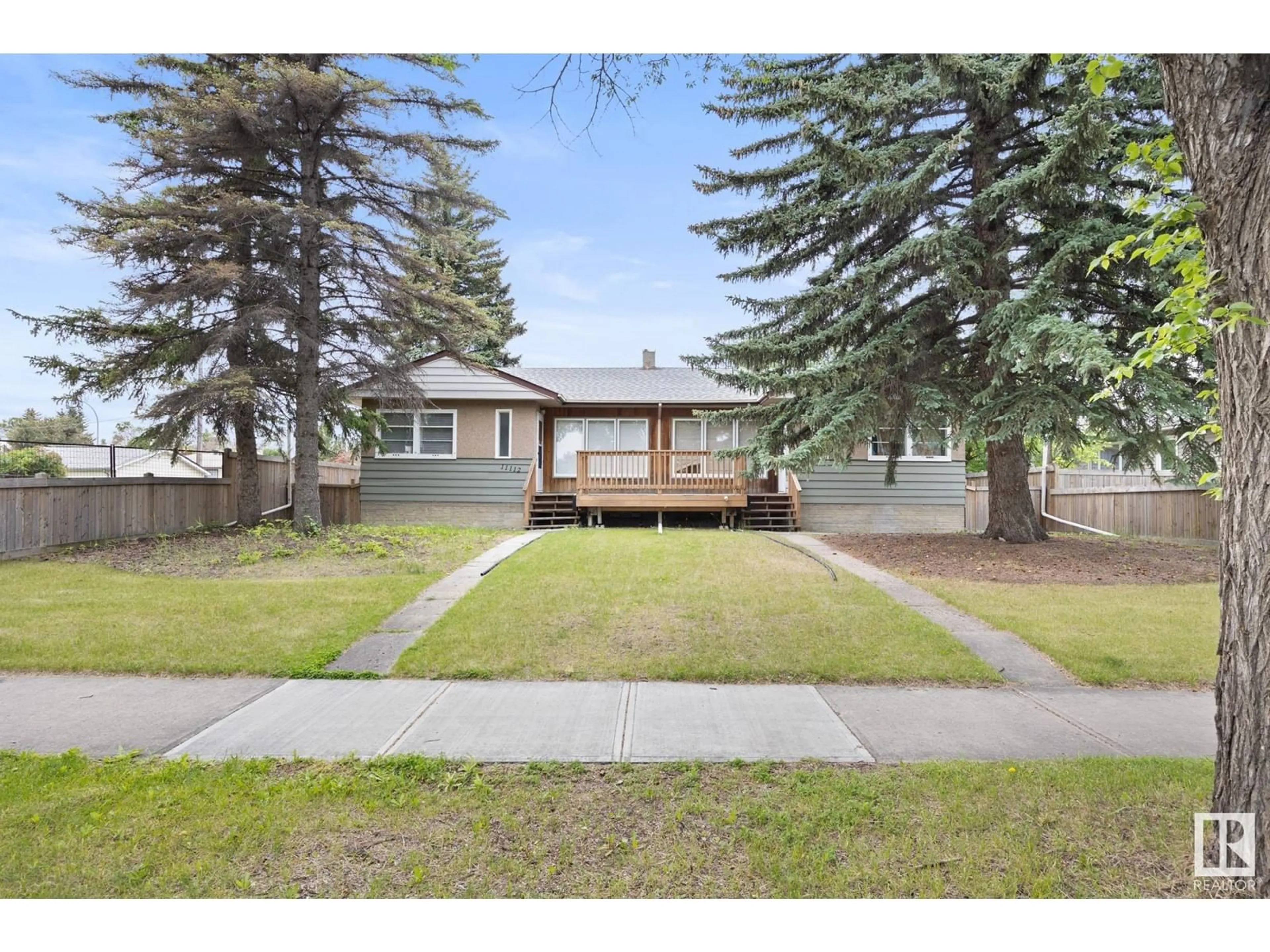 Frontside or backside of a home, the fenced backyard for 11112/11116 116 ST NW, Edmonton Alberta T5G2V6